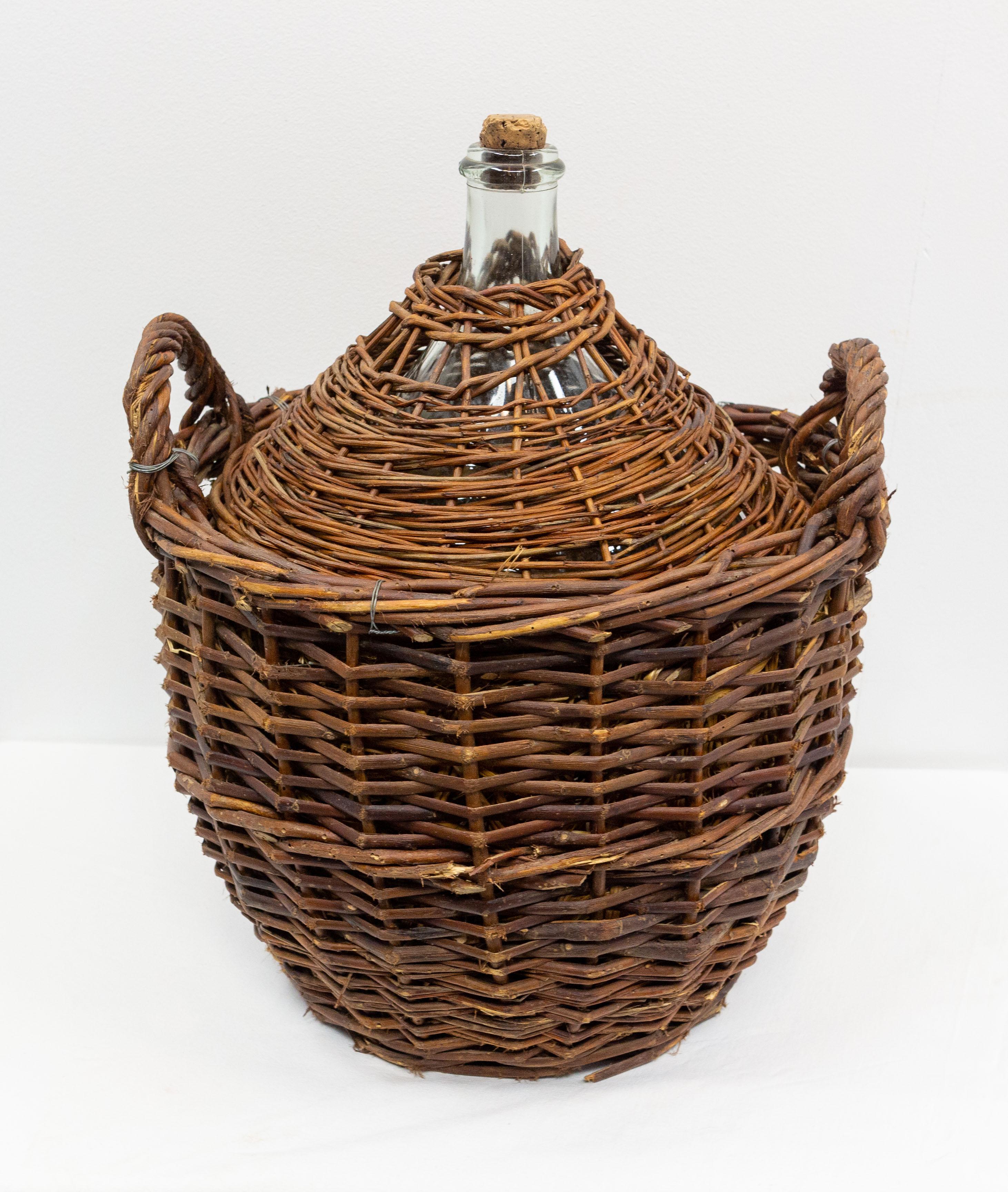 Dame Jeanne or carboy antique glass bottle demijohn.
The carboys were often protected from shocks and temperature variations into a wicker basket. Between the bascket and the bottle, some straw was added.
This king of dame jeanne is rare because