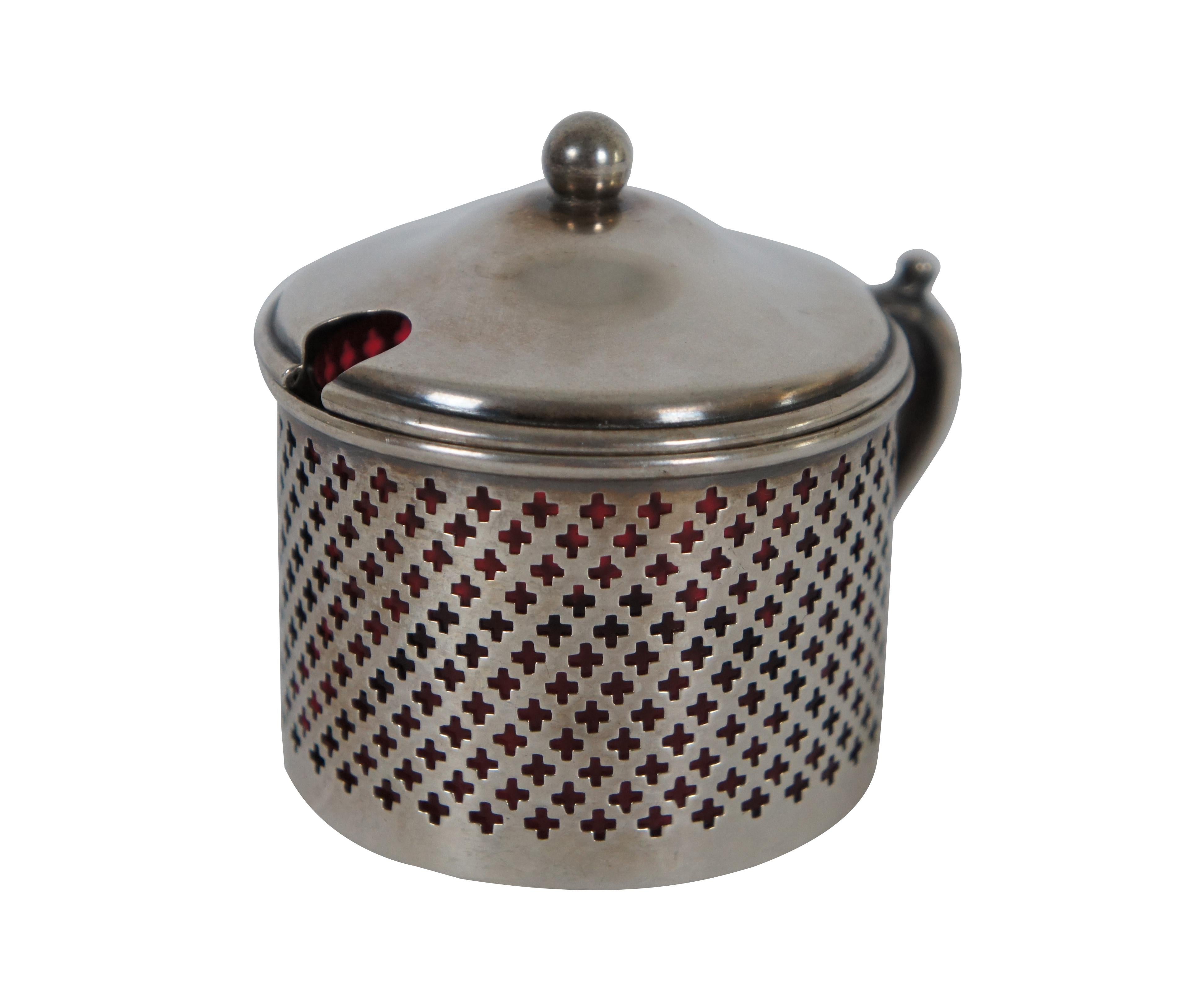 Antique Whiting number 3534 sterling silver lidded jam / mustard / condiment pot with cranberry glass insert. Handled overlay features reticulated cross sides and a ball finial on the lid. No monogram. Weight 51.2 g
