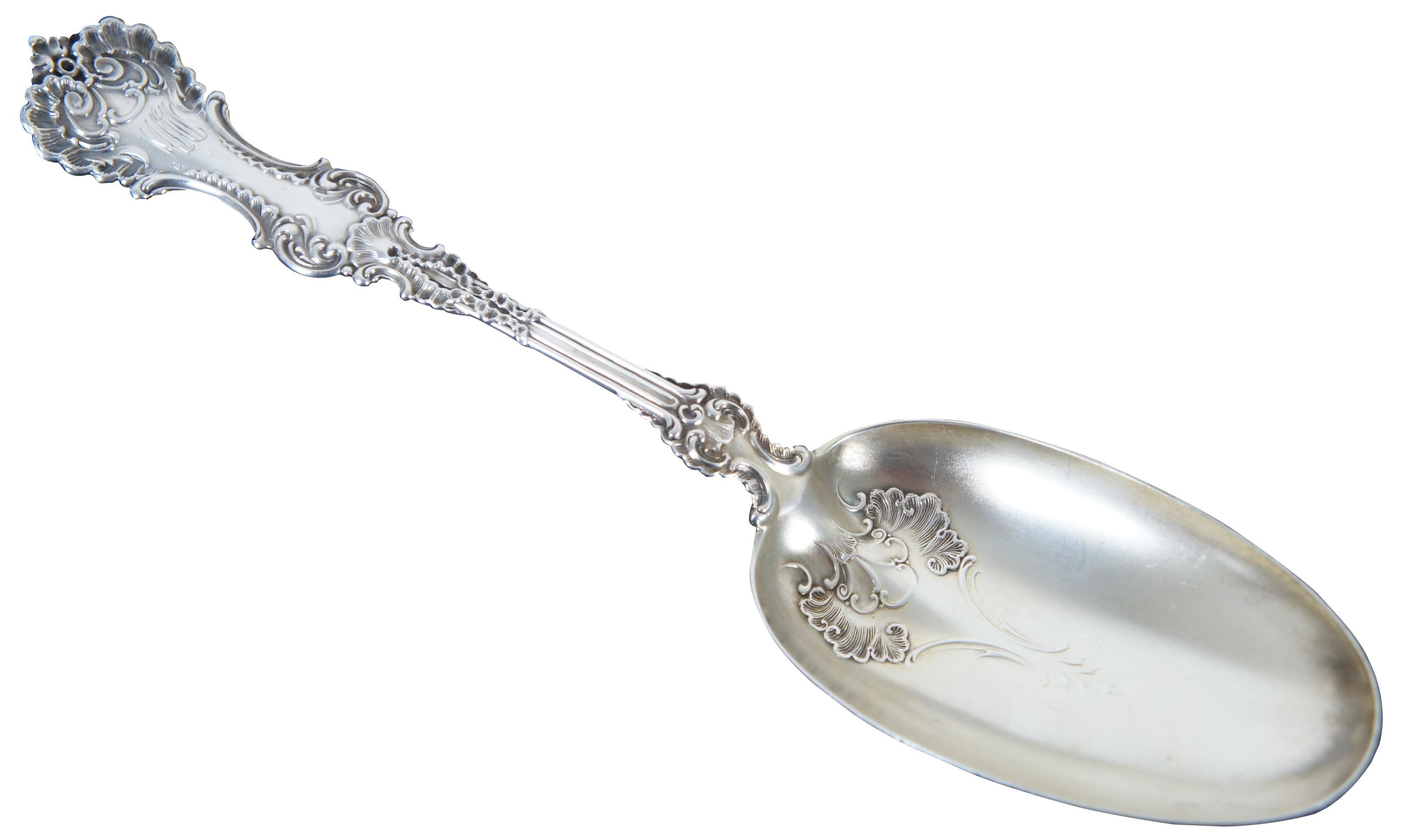 Antique Whiting Manufacturing Company sterling silver serving spoon in the 1895/1898 Pompadour pattern designed by Charles Osborne and monogrammed. Measures: 9