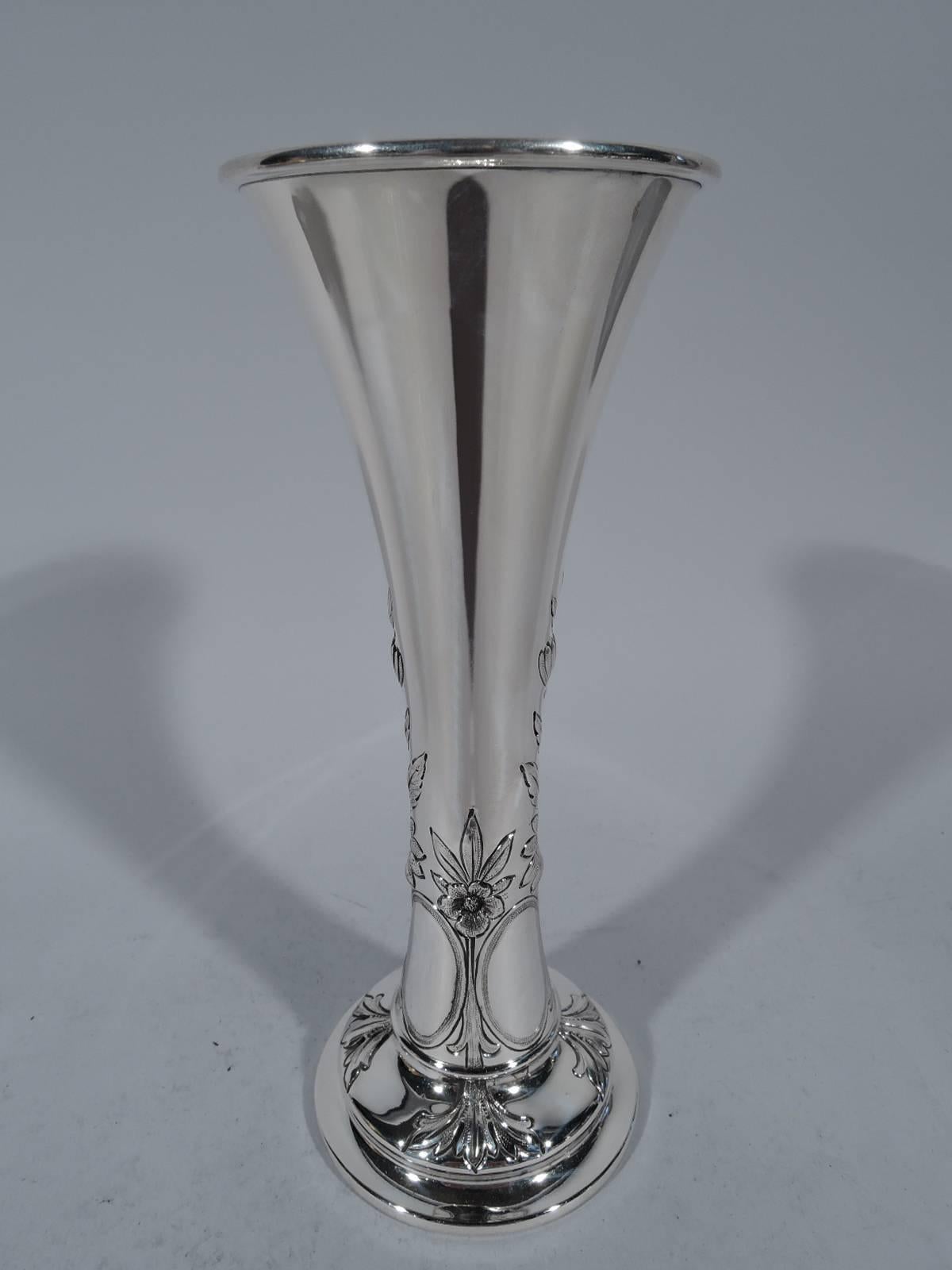 Edwardian sterling silver vase. Made by Whiting in New York in 1911. Tapering cylinder on stepped round foot. Chased vertical ornament in form of flowers and oval frames (vacant). Hallmark includes date symbol and no. 891. Weighted.