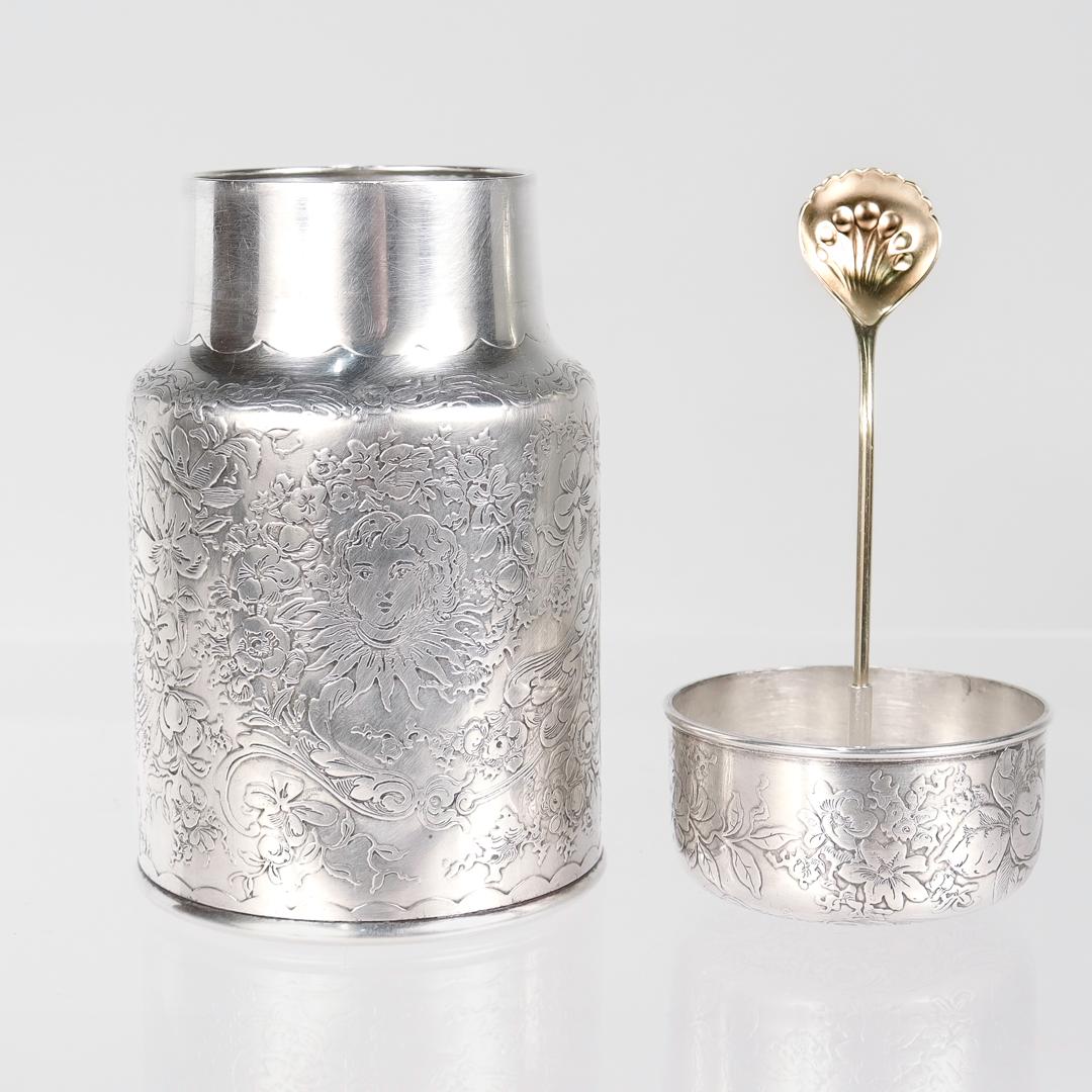 A fine antique silver powder jar.

By Whiting Manufacturing Co.

In sterling silver with an integral gilded spoon in the lid.

With intricate engraved decoration throughout of various flowers, floral swags, geometric patterns, and faces of young
