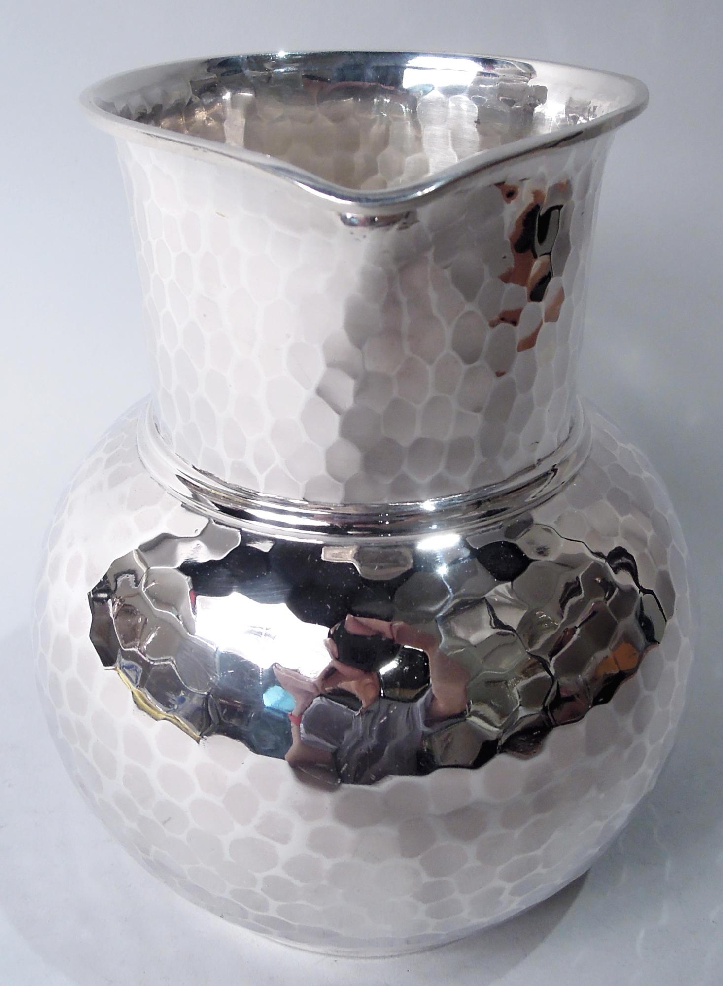 Japonesque Craftsman sterling silver water pitcher. Made by Whiting in New York, ca 1885. Drum form neck and globular bowl on short and straight foot ring; c-scroll handle and small lip spout. Allover spot-hammering. Fully marked including maker’s
