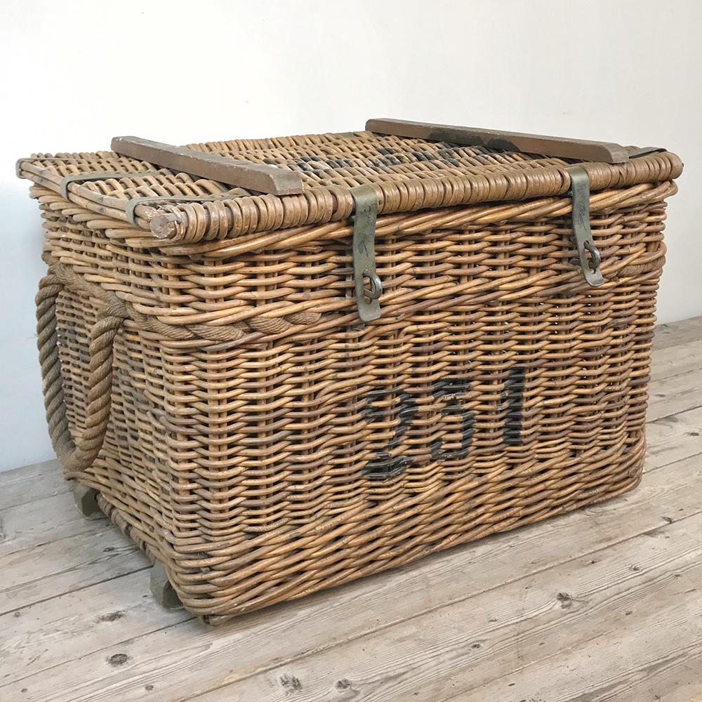 Antique wicker basket is an unusual example, with large stenciled numbers, wooden reinforcements and steel hasp locks, indicating it was used in a commercial or Industrial capacity and built to take heavy use, although it shows surprisingly light
