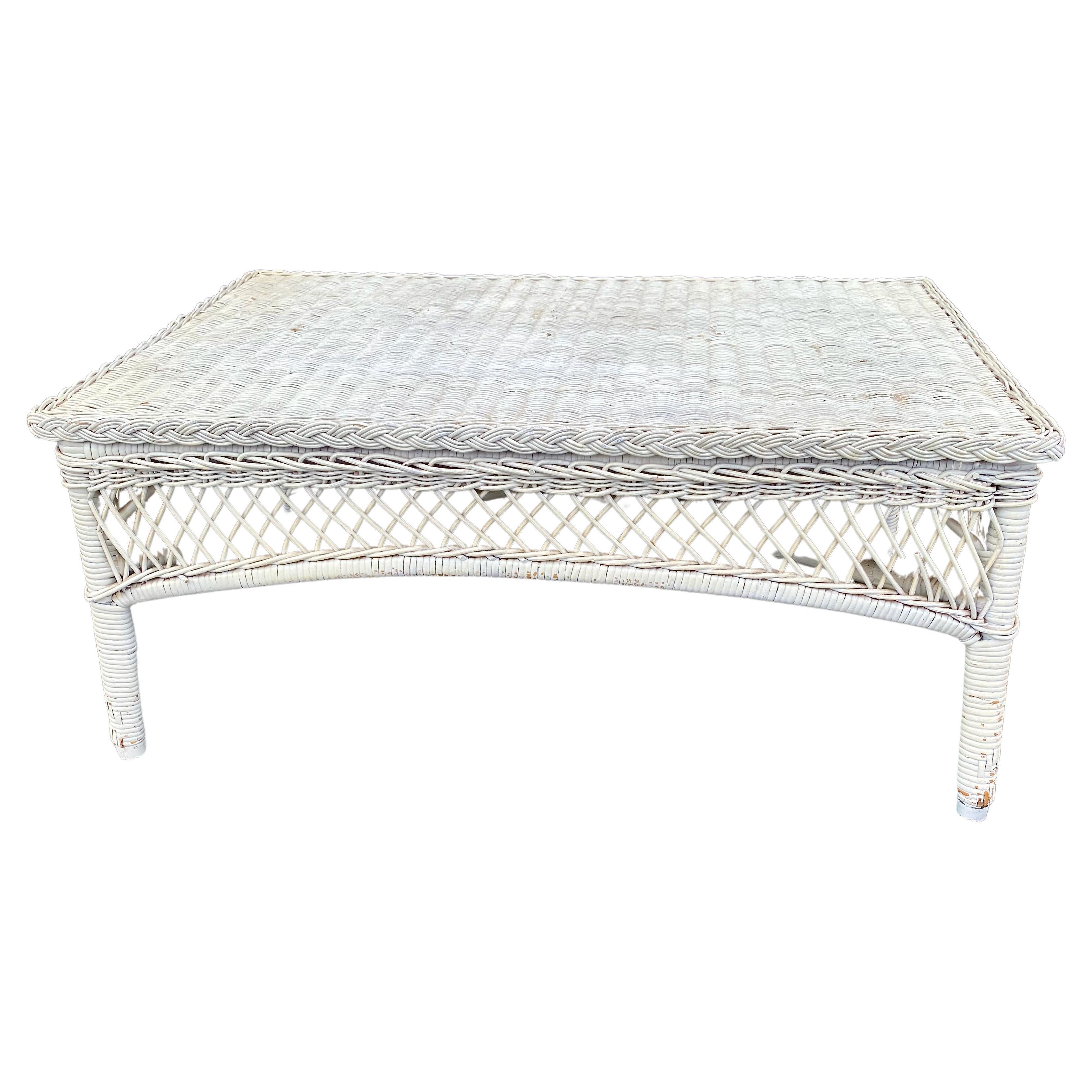 This is a charming all wicker coffee table that dates to circa 1930 -1940. and is most probably a Bar Harbor piece. The table features a woven rolled edge construction and a lower wicker shelf. The table is in very good original condition with minor