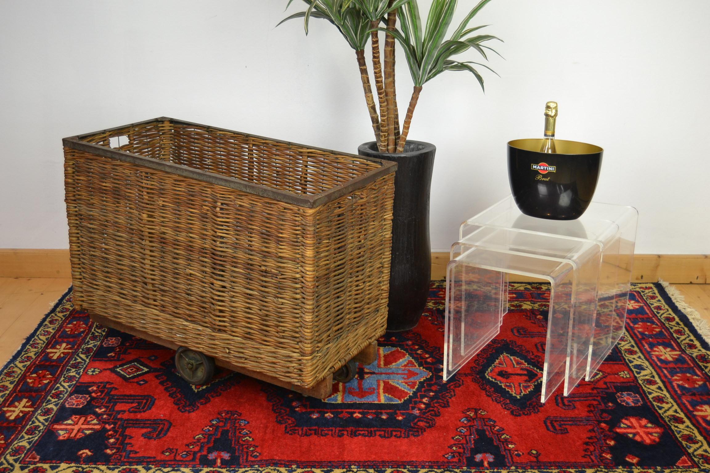 Antique wicker factory basket on wheels - basket trolley - laundry trolley.
This old wicker trolley cart on wheels is a great decorative object as well a useful object:
for the laundry, storage basket for toys, fireplace wood, newspapers and