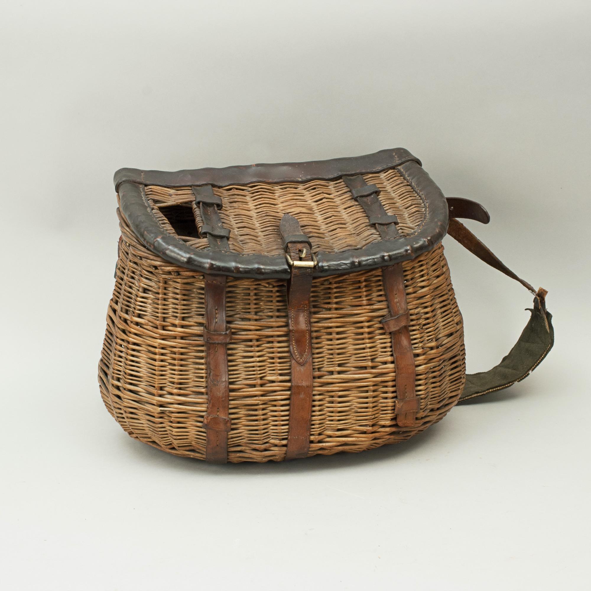 Vintage wicker creel.
A very good example of an early wicker fishing creel. The finely woven wicker creel is made in the traditional design and is with leather trim and leather and canvas shoulder strap.
The creel was an important piece of