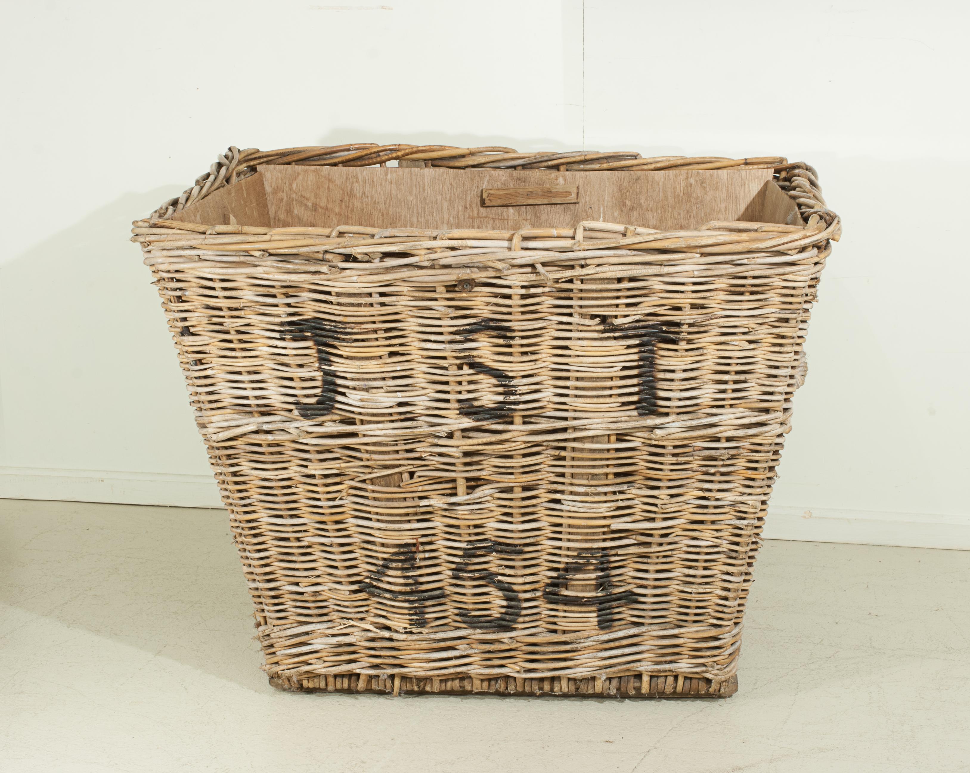Large industrial Wicker basket. Fire wood or log basket.
A large early 20th century English rectangular willow wicker basket. The basket topped with a twisted trim, tapering sides and wooden runners. The front stenciled with 'JST 454', this could