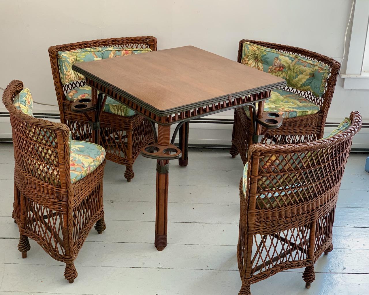 An early and unique card / game table with four matching Bar Harbor style chairs.The five piece set consists of a natural finished quarter sawn oak topped game table and four matching chairs. The table and chair bodies are done in a simple