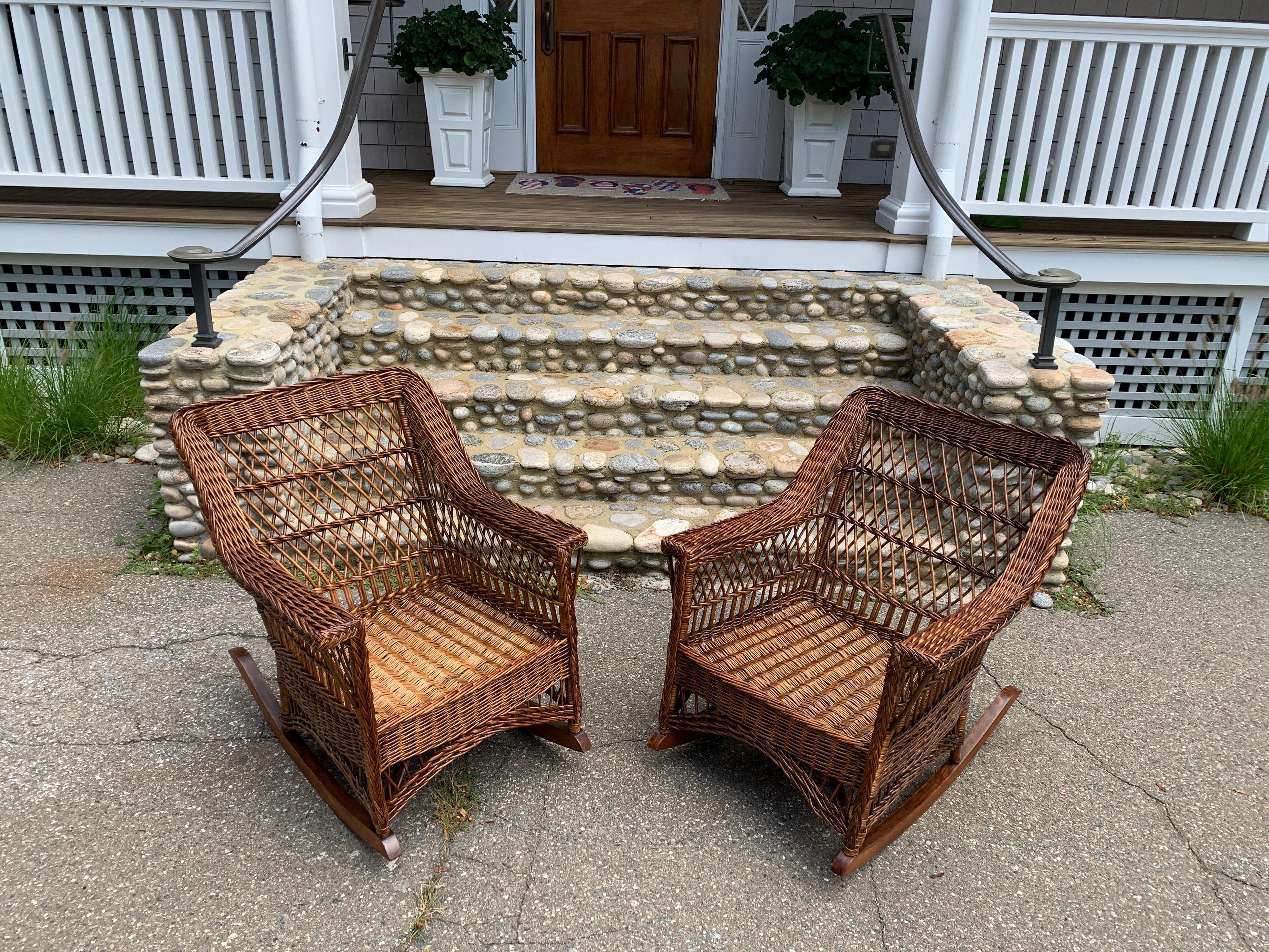 A beautiful pair of antique wicker rockers woven of willow in a natural stained finish. Chairs measure 28” wide, 36” deep, 33” tall with a seat platform height of 14” without a cushion.