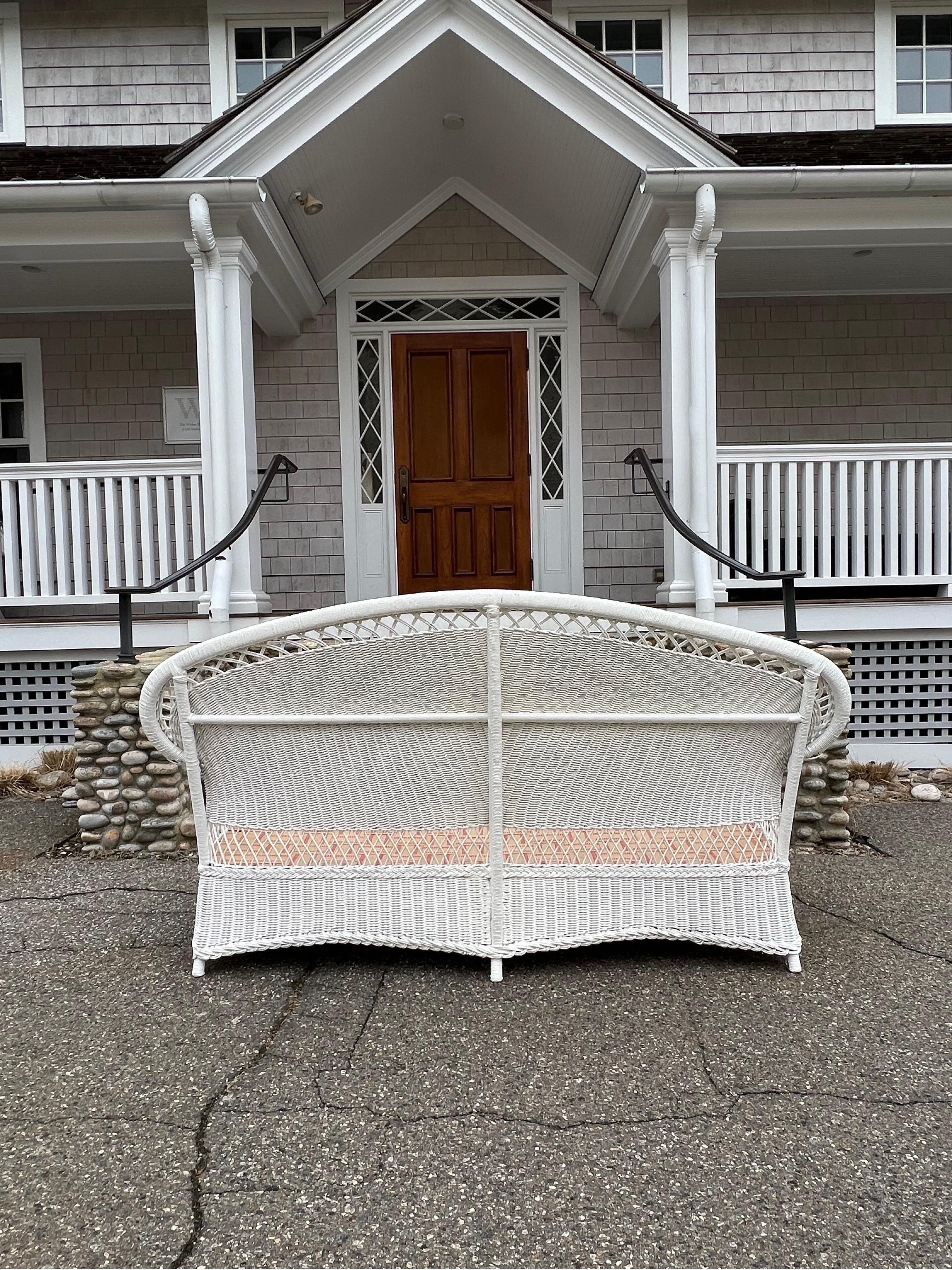 This is an antique wicker sofa that was made by the Merikord Company. It measures 78” wide, 29” deep and 40” tall. A comfortable and sturdy piece.