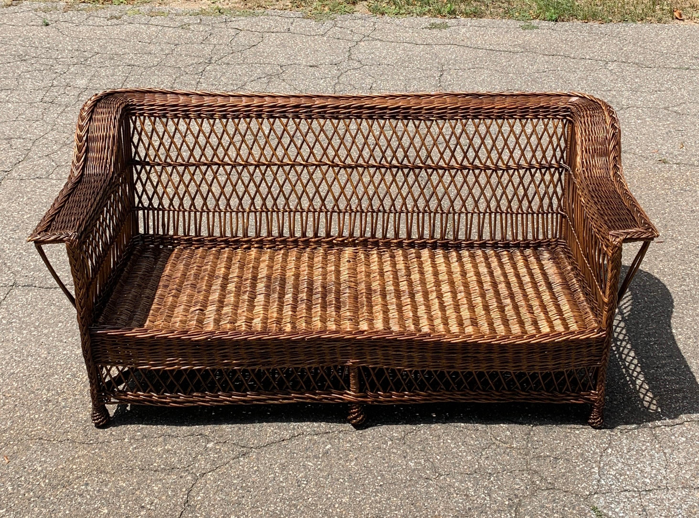 Antique wicker sofa woven of willow with a natural stain finish. Sofa measures 72