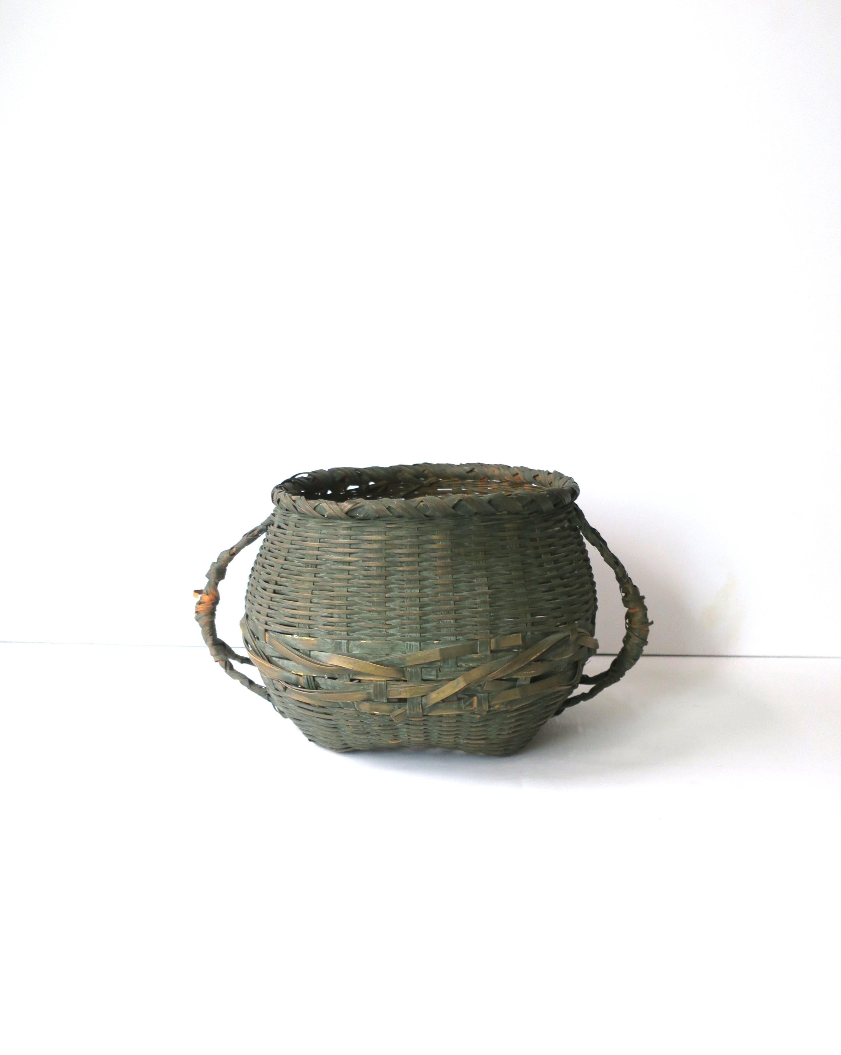 An antique wicker green splint basket with handles, circa early 20th century, USA. Dimensions: 9.5