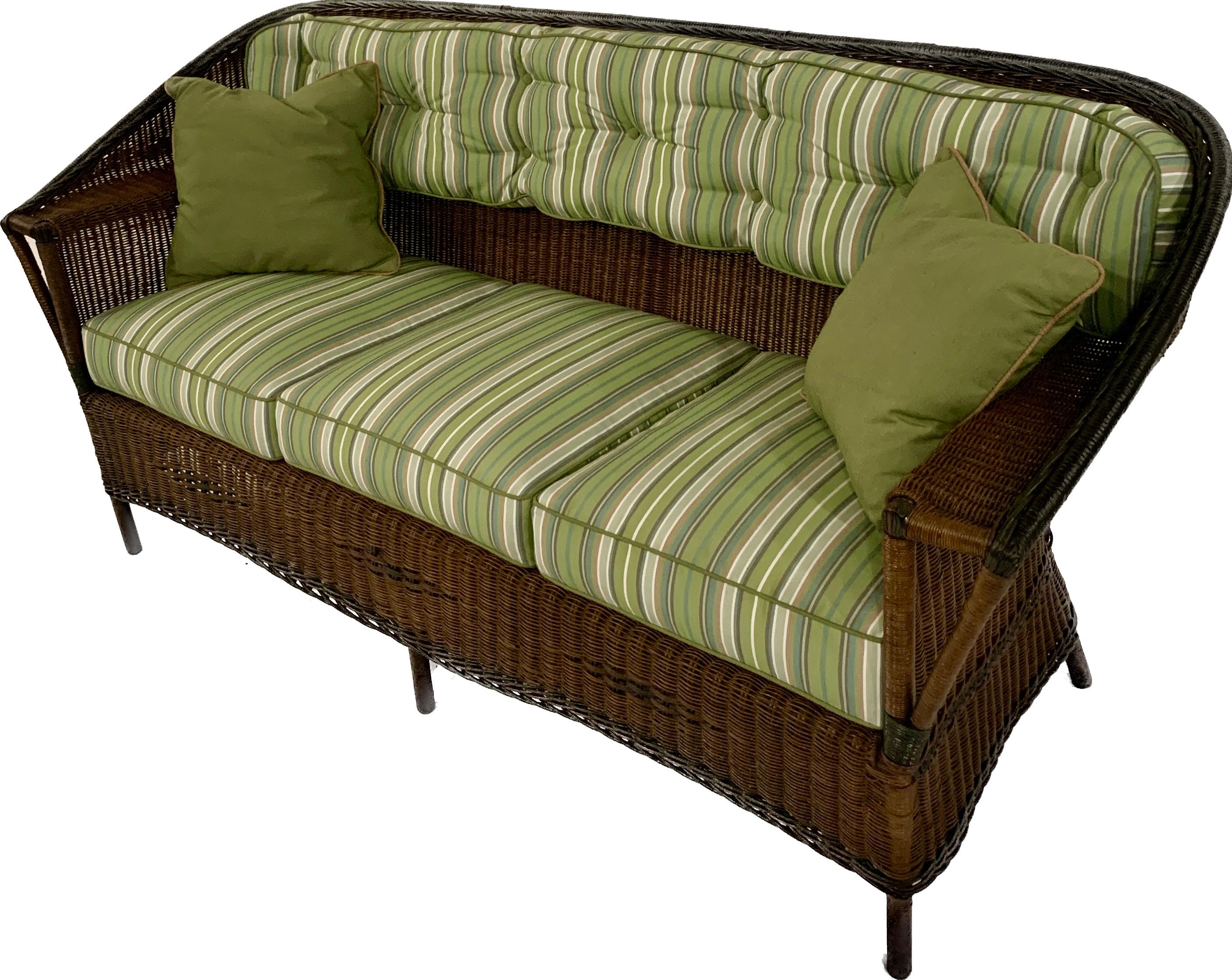 A beautiful matching three piece Antique Wicker Suite in natural finish with colored trims in sienna, green and black, American,C. 1920.
This closely woven suite is magnificent in its design! Each piece in the set is closely woven in natural