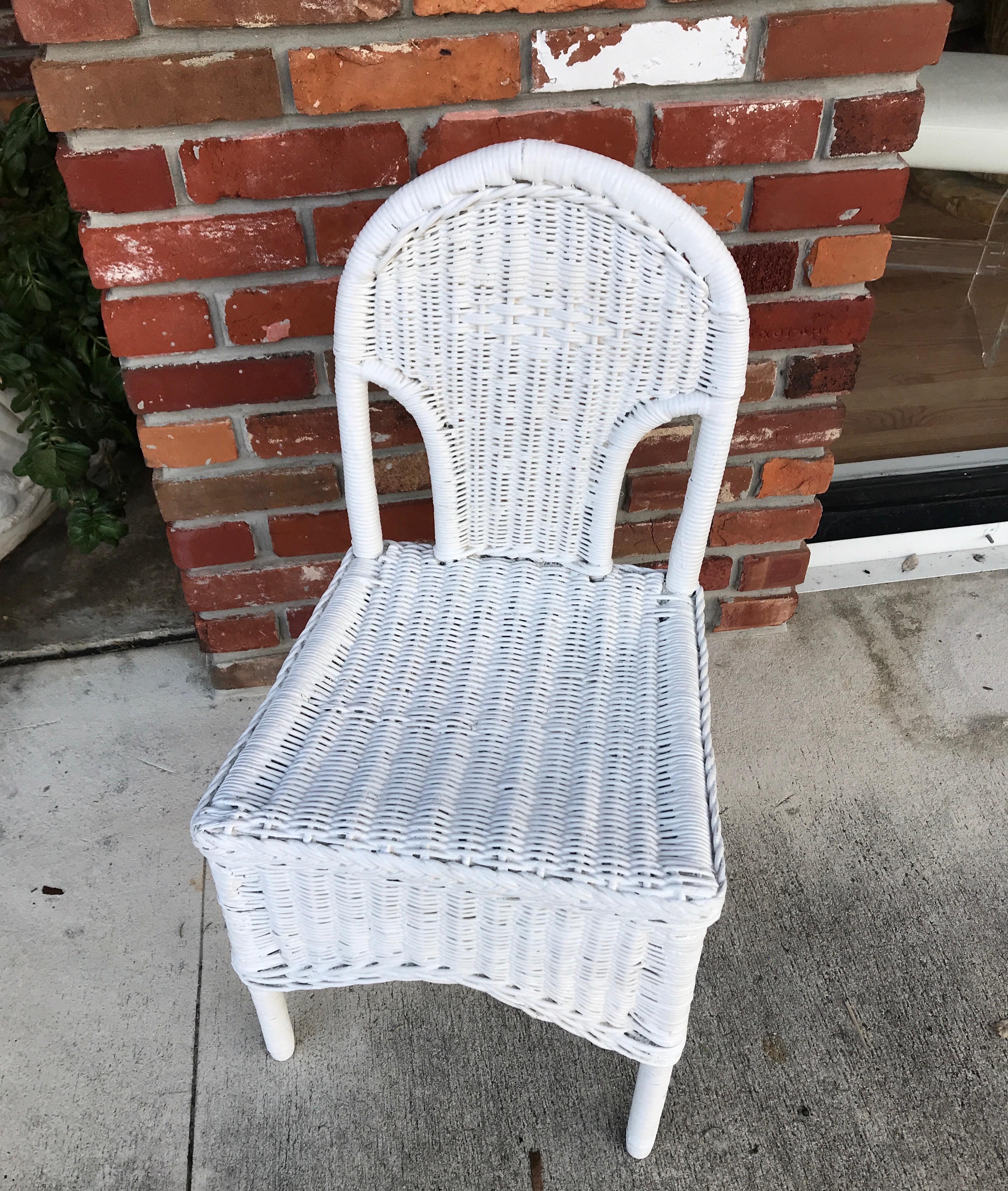 Antique white wicker vanity or desk chair with a skirted apron.