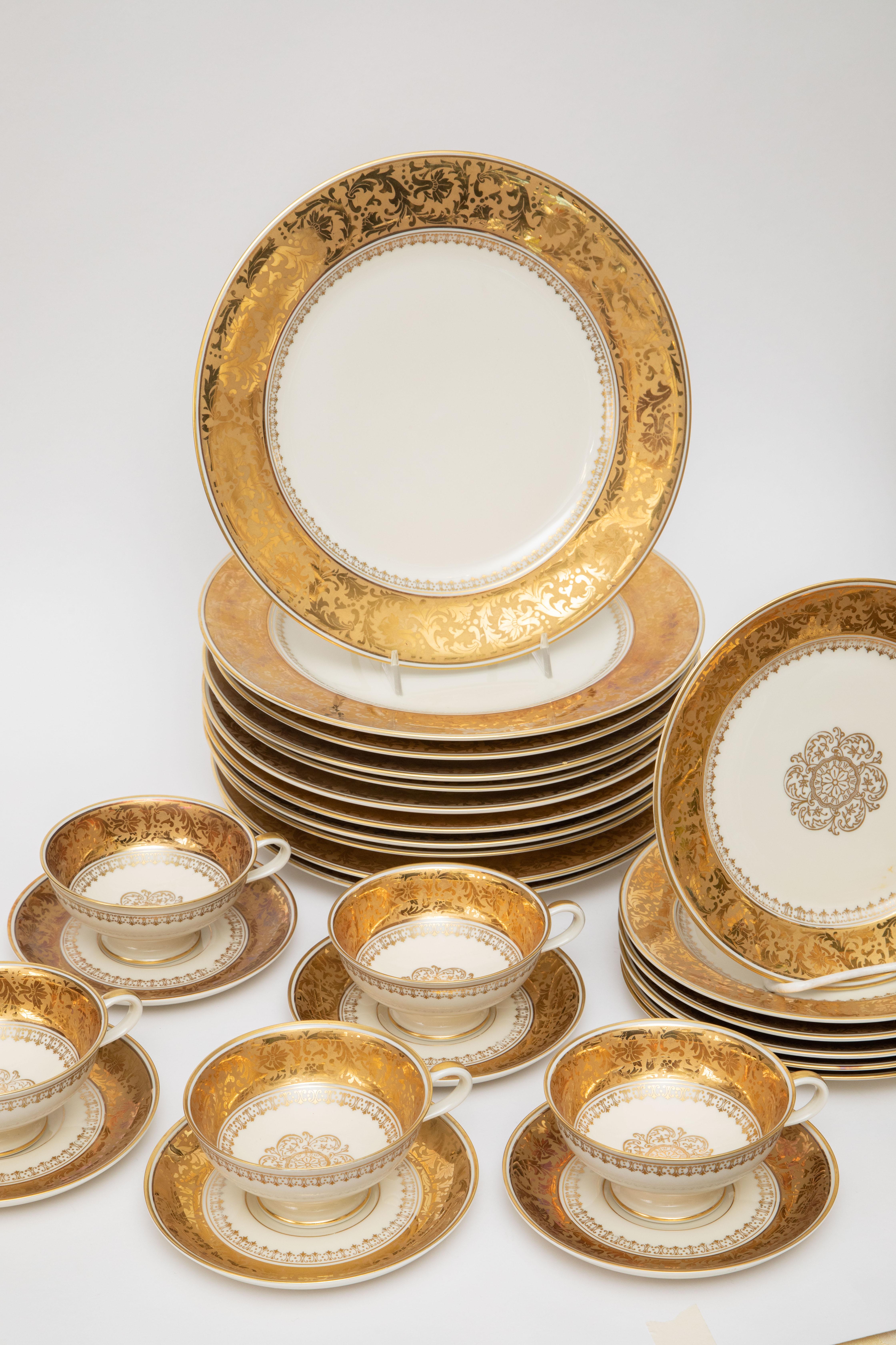 A wonderful porcelain set with a floral scroll 24 karat gilt decorated collar and the salad or dessert plates featuring a central medallion. Made and decorated by the Royal Bavarian companies of Rosenthal and Thomas, this partial set features:
22