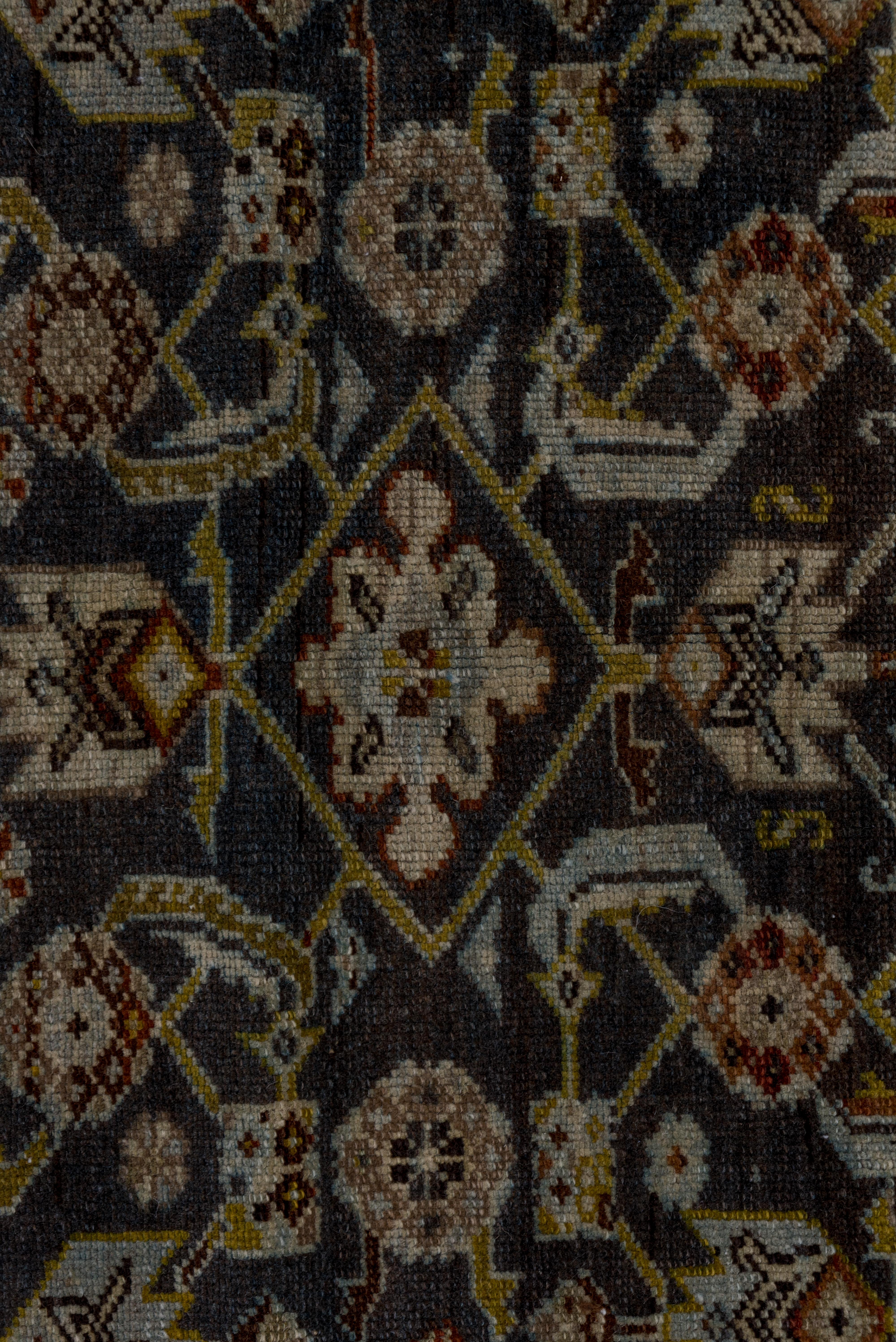 This characteristic west Persian rustic runner displays a single column Herati design on a noticeably abrashed brown field. The palmettes are schematically drawn and the diamonds are flattened with snowflake rosette fillers. The ivory main border
