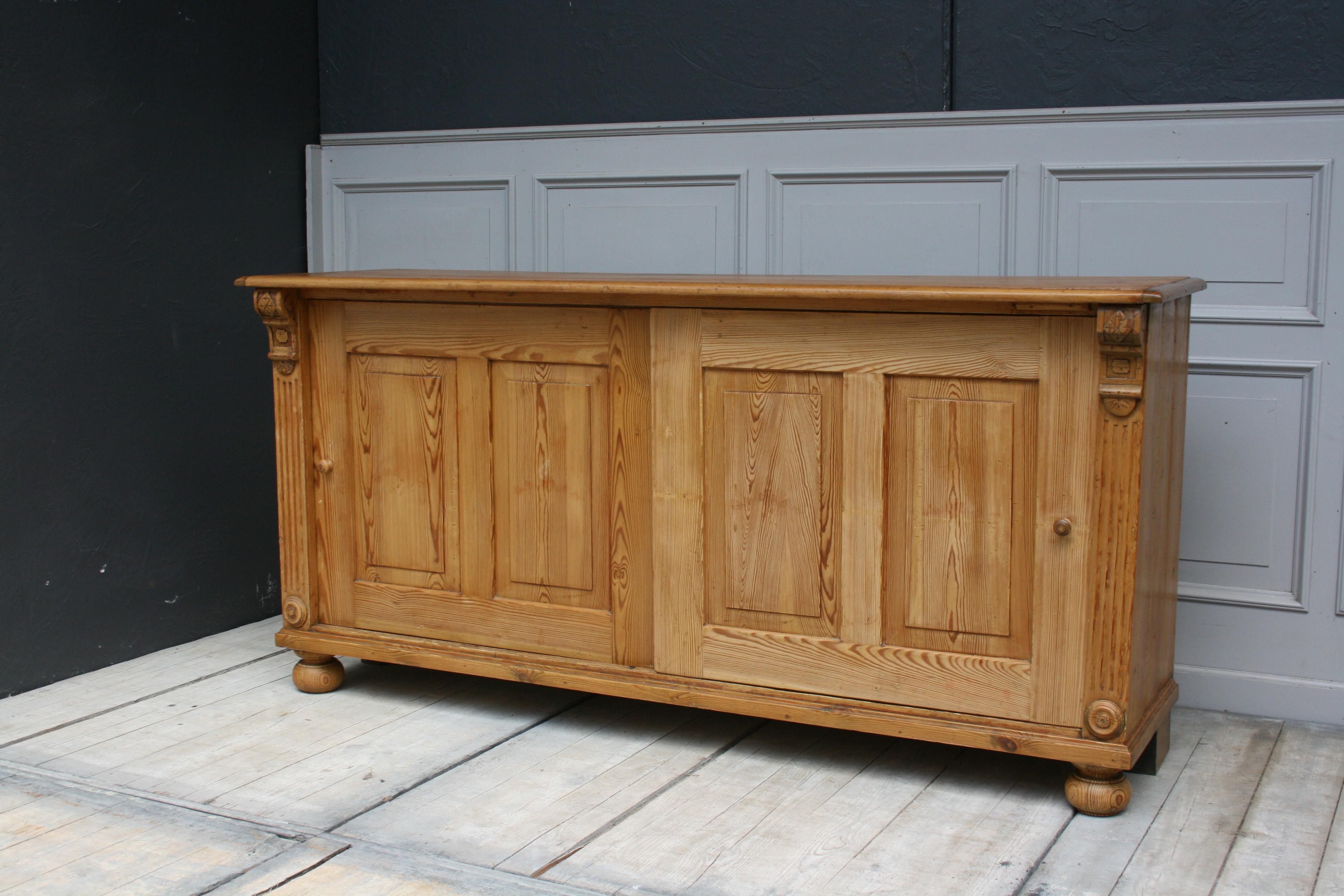 Original Old Wilhelminian sideboard with sliding doors made of fir wood, circa 1860-1870. Refurbished ready for home. The body of the furniture is waxed. The plate was completely sanded and painted several times with transparent parquet