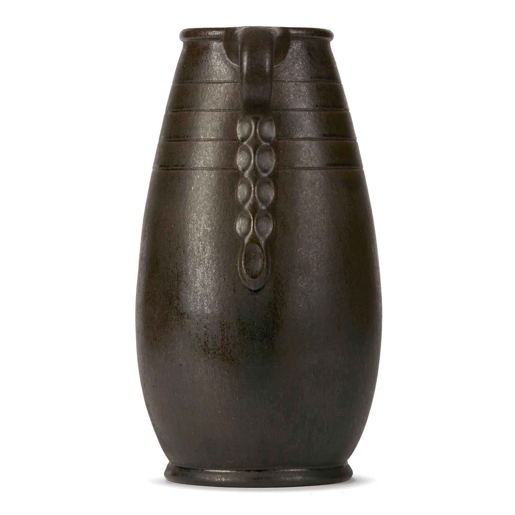 PLEASE NOTE: This piece is currently located in our Amsterdam office, please enquire for delivery times. 

A large and impressive art pottery twin handled vase by renowned Dutch master potter and sculptor Willem Coenraad Brouwer. This stylish