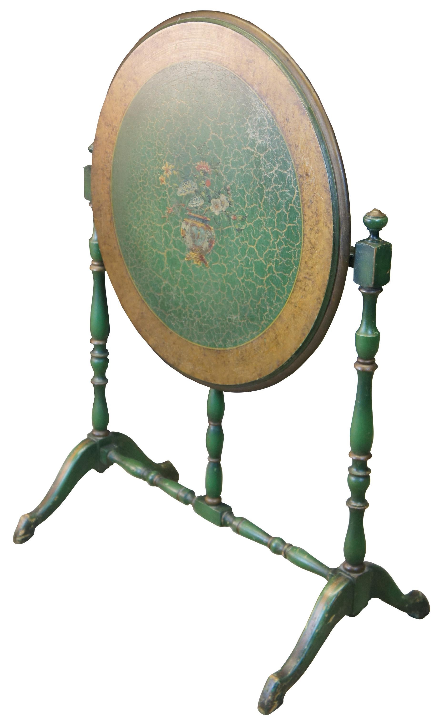Early 20th century William & Mary style side/ tea table. Features turned supports system support system with trestle base supporting a round tilt top. Finished in green and gold with painted floral vase motif along the center.

Measures: 27