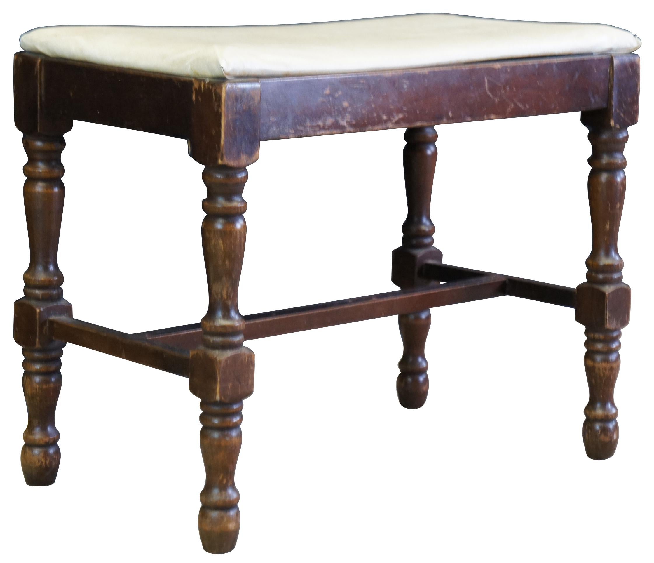 William and Mary bench or foot rest, circa first half 20th century. Made of walnut featuring turned legs connected with H strecher and upholstered seat. Measure: 22