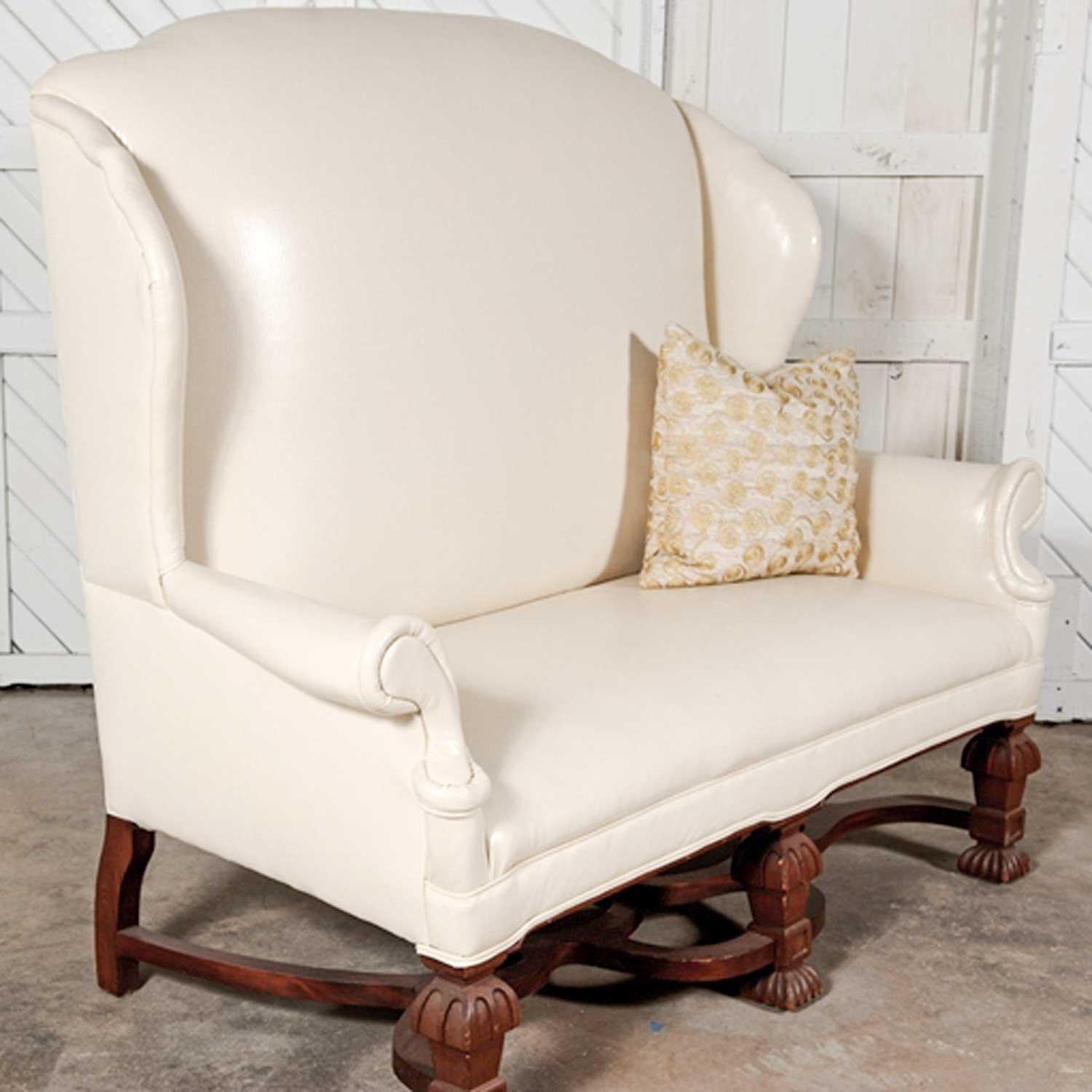 Beautiful Antique William and Mary Wingback settee with white faux leather upholstery and solid wood ornate base and feet. In excellent condition. Age appropriate wear to the feet. Please see photos. 

Just get a load of this stunning high-style,