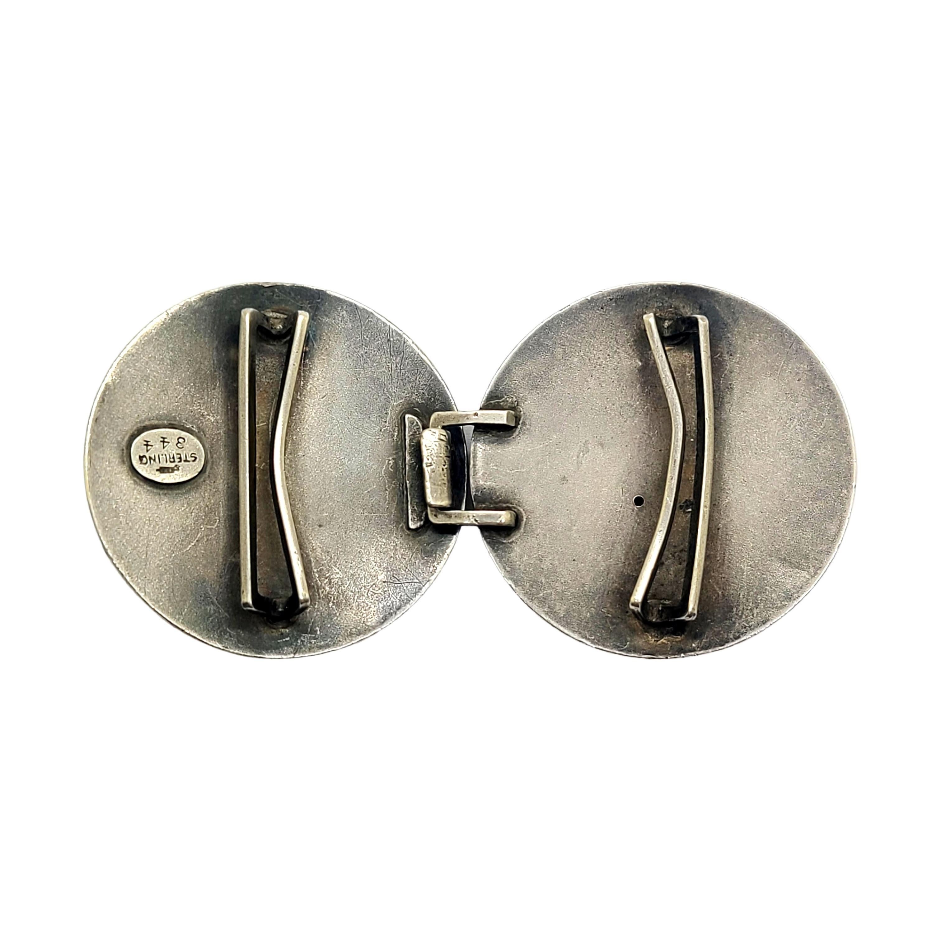 Sterling silver 2pc belt buckle by William B Kerr.

2pc round belt buckle featuring small round pink cabochons.

Measures approx 1 9/16