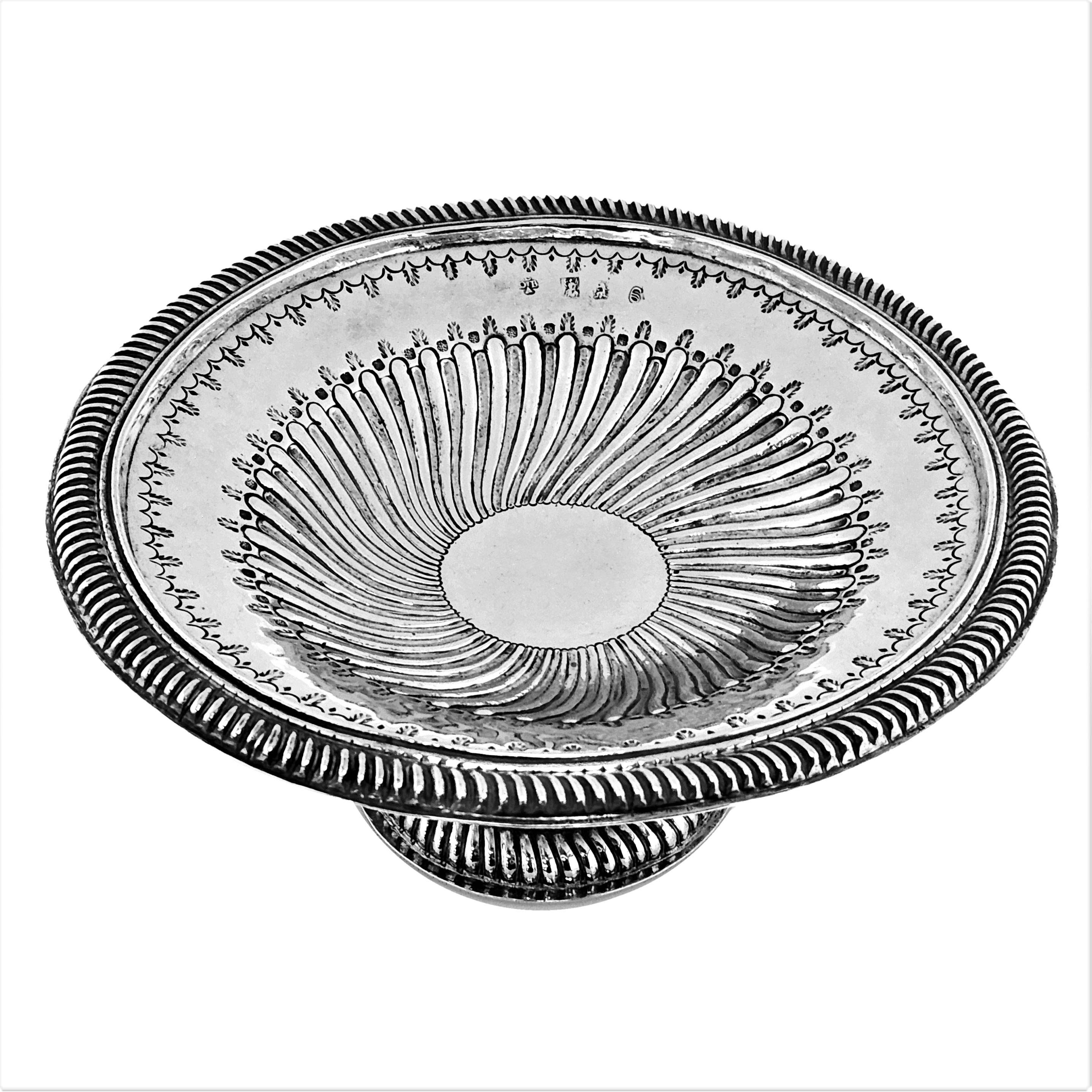 A rare and impressive Antique William III Britannia Silver Tazza. This 17th century Solid Silver Dish has an unusual writhen fluted pattern around the centre of the bowl and is embellished with a gadrooned border on the rim and spread pedestal foot.