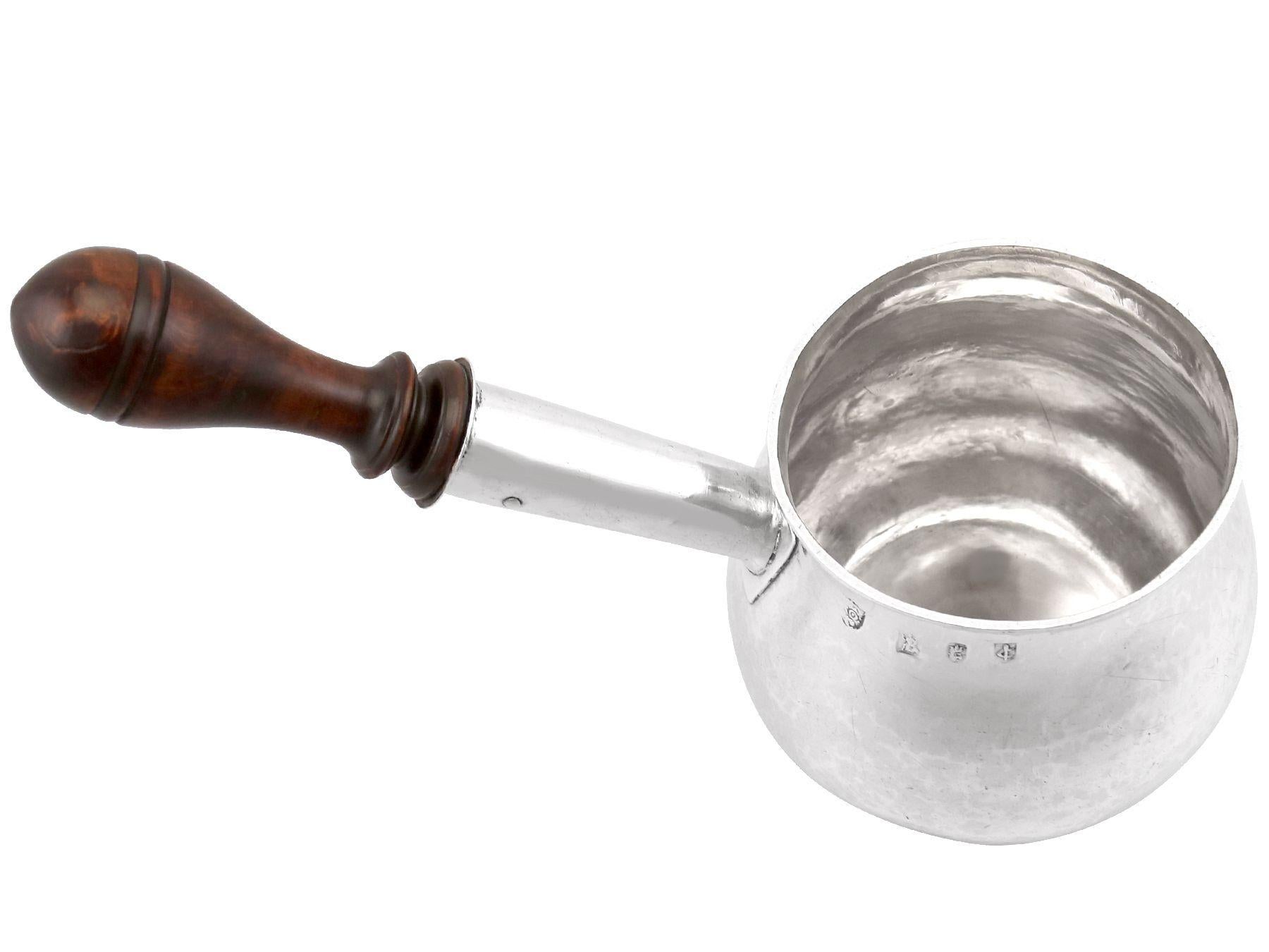 An exceptional, fine antique William III English Britannia standard silver brandy pan; an addition to our collection of 17th century silverware.

This exceptional antique William III Britannia standard* silver brandy pan has a plain circular