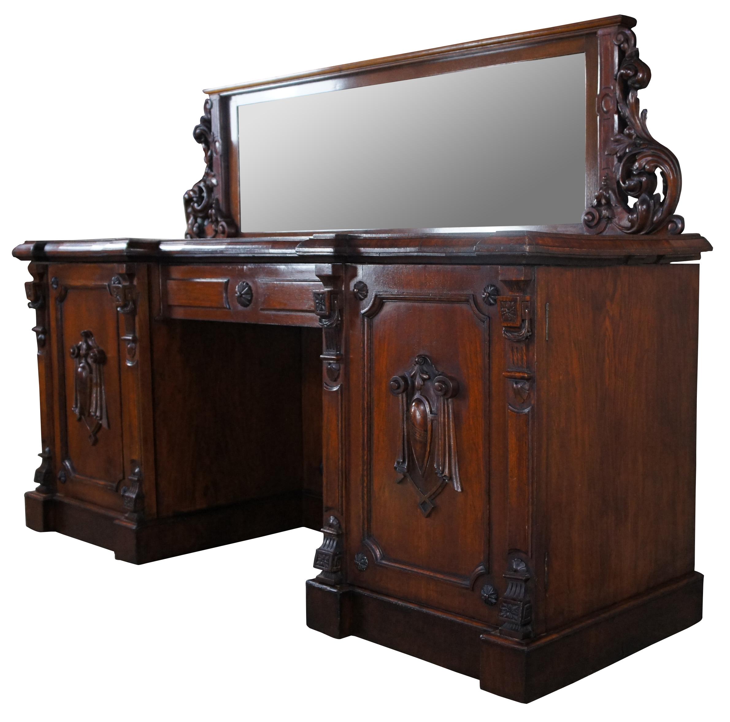 Monumental William IV twin pedestal sideboard, server or barback, circa first half 19th century. A rectangular breakfront form made from oak with ornately carved acanthus scrolling backsplash. Features a large central drawer flanked by outer