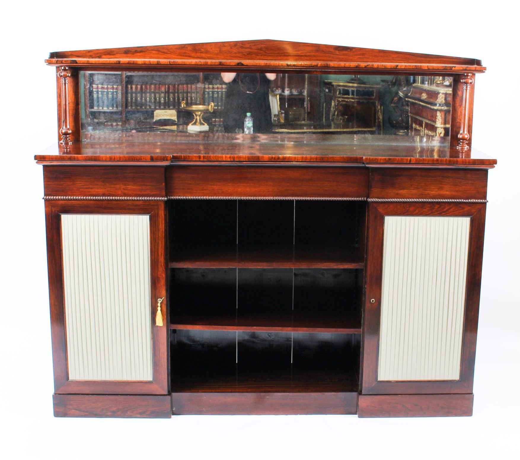 This is a beautiful antique William IV Gonçalo Alves chiffonier, circa 1835 in date.

It has a central open bookcase with adjustable shelves and plenty of space for displaying your favourite books. There are a pair of panelled doors, one on either