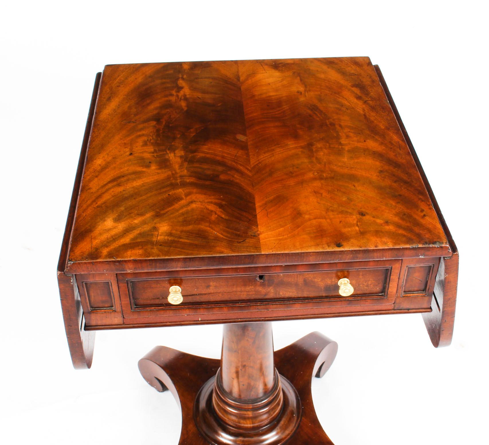 An exquisite antique William IV flame mahogany drop leaf work table, circa 1830 in date.

This beautiful work table has a useful frieze drawer with a paneled drawer front and features Y-pattern supports with a sturdy turned centre column and a