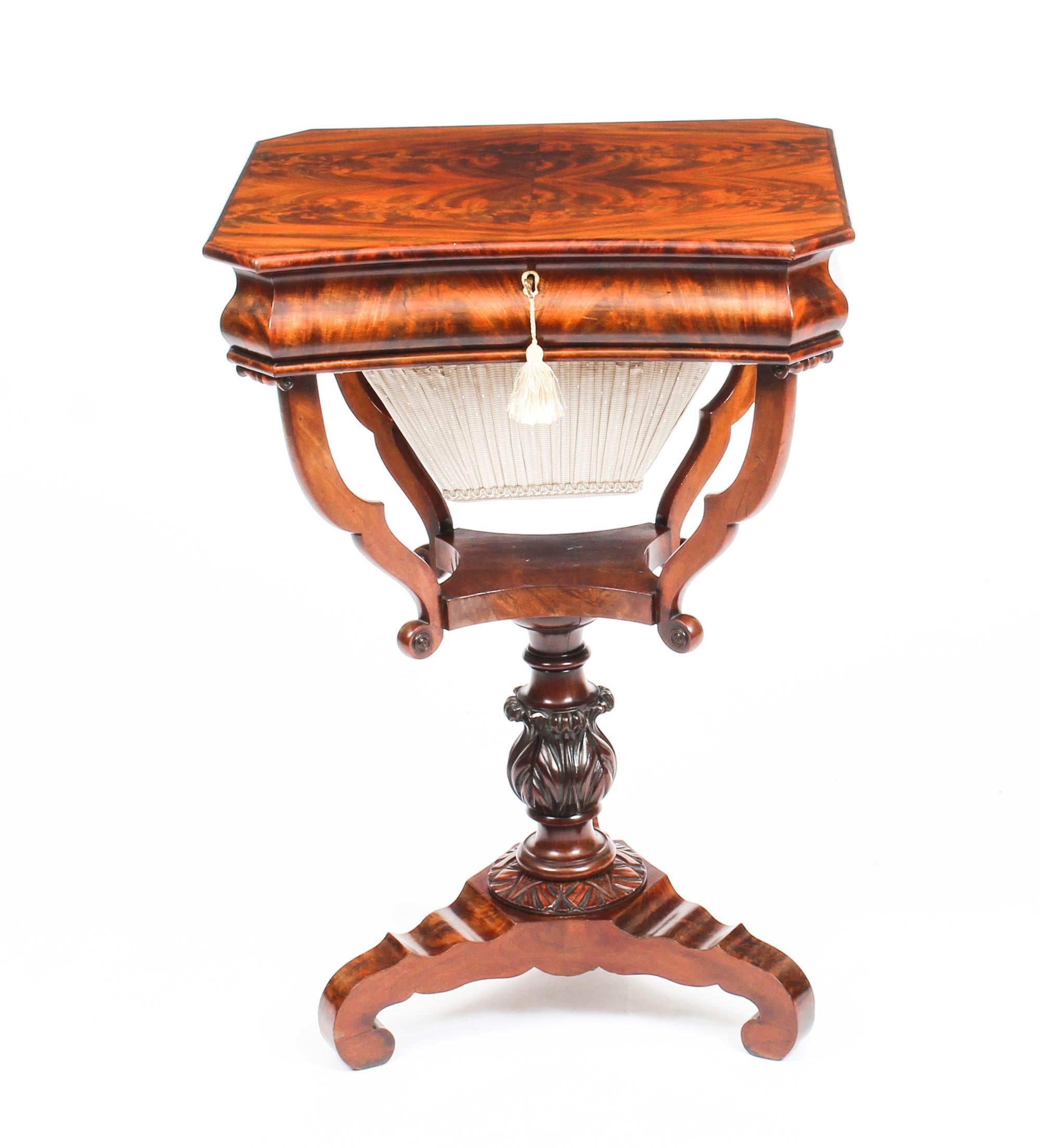 A beautiful antique English flame mahogany William IV work table, circa 1835 in date.

The hinged lid opens to reveal an interior fitted with various compartments some with fitted lids for your sewing items, a lift up pin cushion, a mirror and a