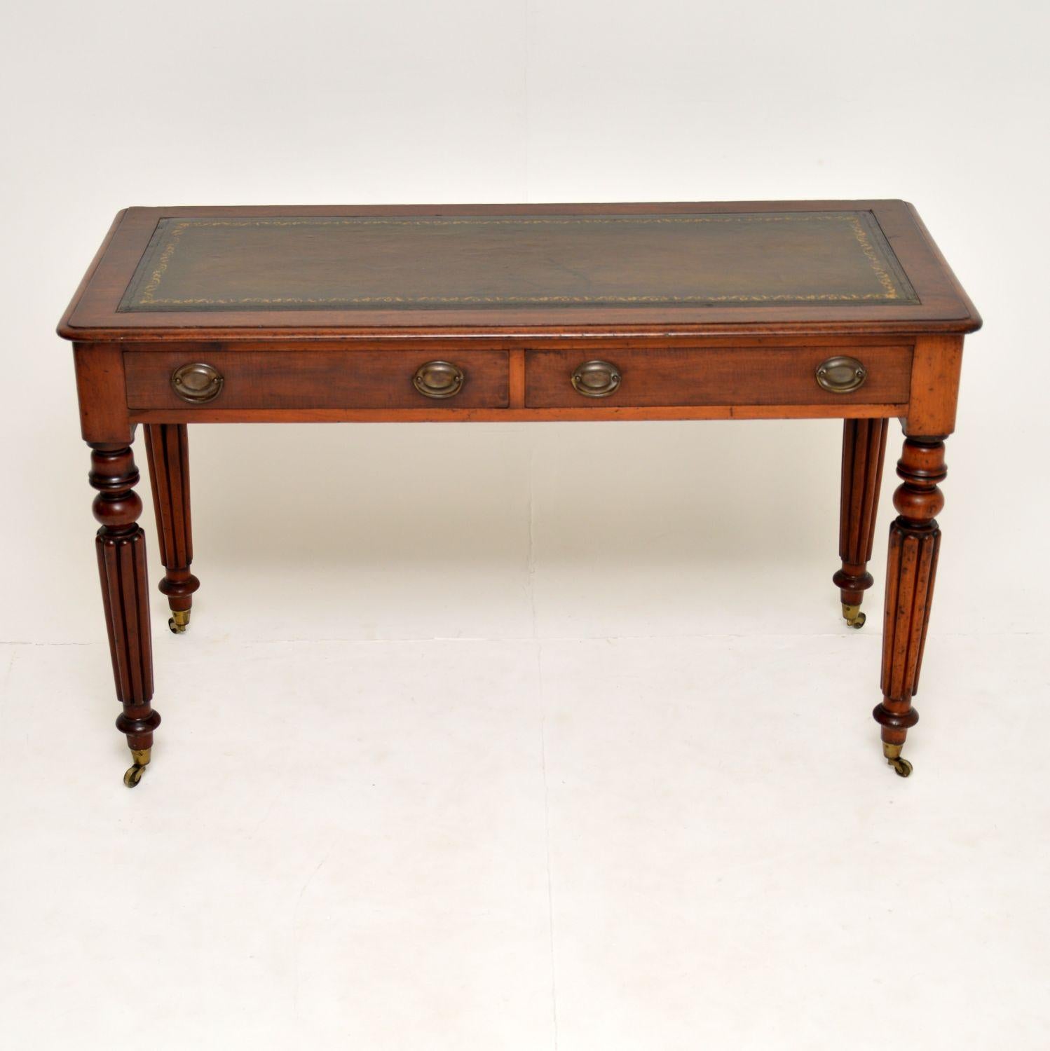 A very well made antique writing table or desk in solid mahogany. This dates from circa 1830s-1840s period.

It has well turned and fluted legs of fantastic quality. It sits on original brass casters, and has brass handles on the drawers.

The