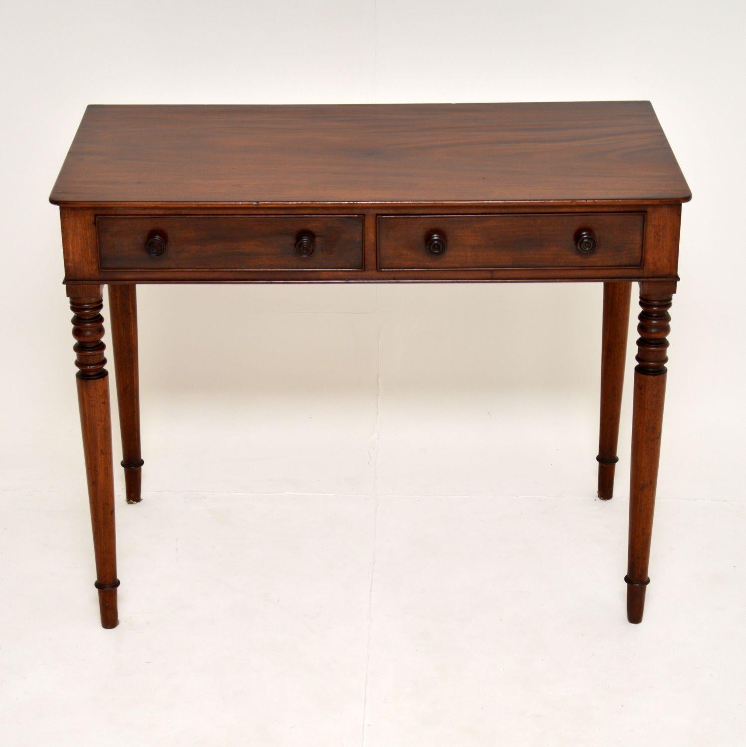 A gorgeous antique William IV writing table in solid mahogany, which could be just used as a side table. This dates from circa 1830-1840 period.

It is of extremely high quality, with beautifully elegant turned legs and handles, and solid wood