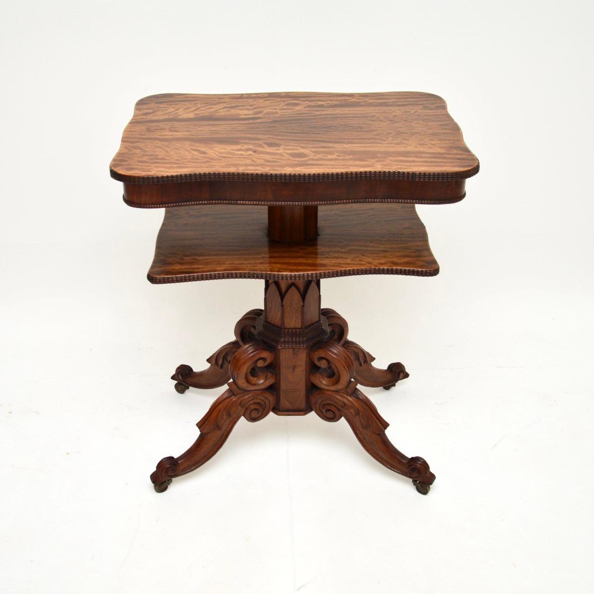 A wonderful antique William IV occasional side table. This was made in England, it dates from the 1830-1850 period.

This is of incredibly fine quality, the base displays beautiful and profuse carving. The top and lower tiers are serpentine shaped,