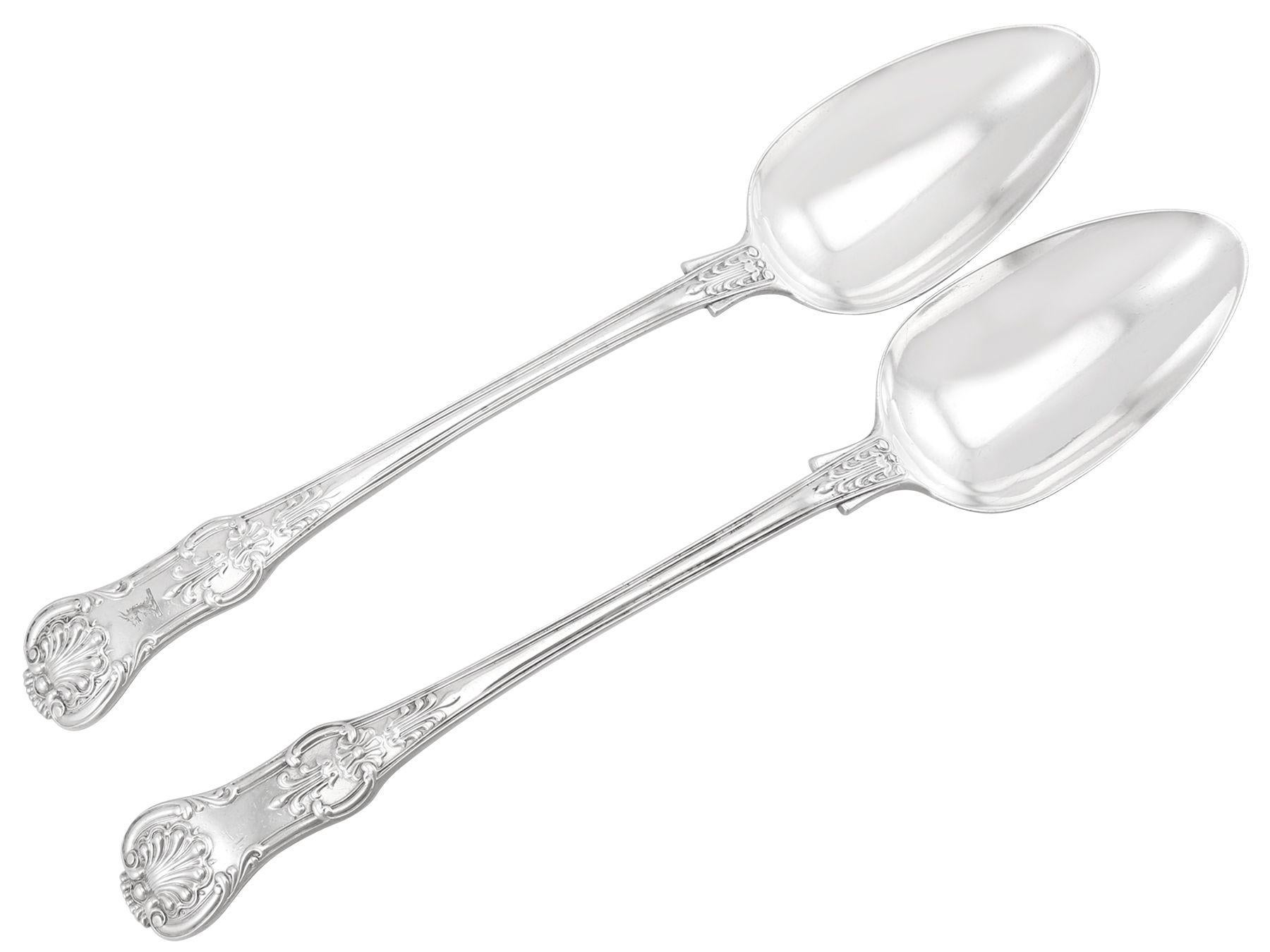 An exceptional, fine and impressive, pair of antique William IV English sterling silver Queen's pattern gravy spoons; an addition to our silver flatware collection.

This exceptional pair of antique silver spoons, in sterling standard, has been