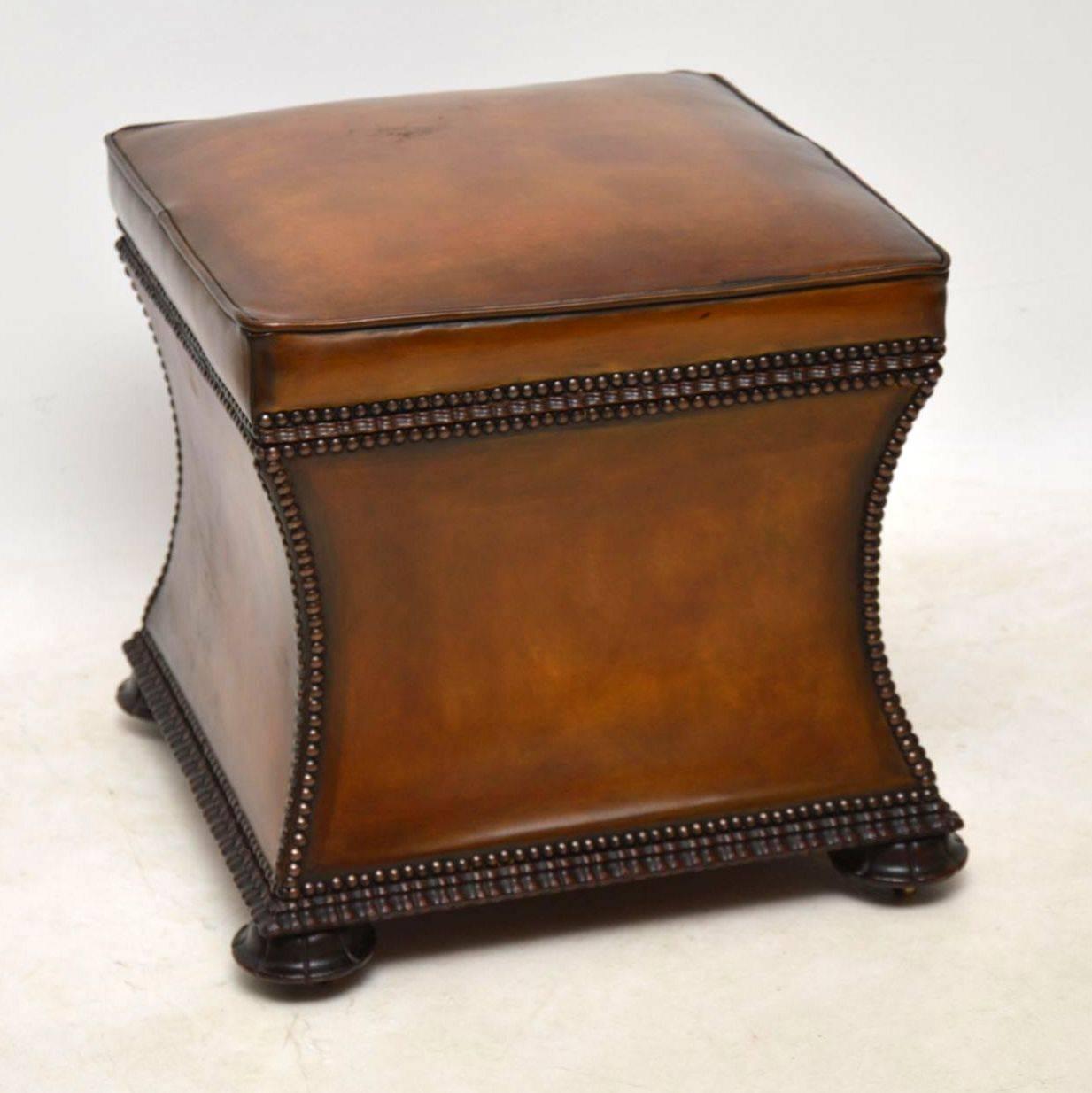 Antique William IV leather upholstered ottoman with useful storage inside. It has a padded seat, concave sides and a hinged seat that lifts up to reveal a newly upholstered interior. The leather is hand colored showing loads of character and it's