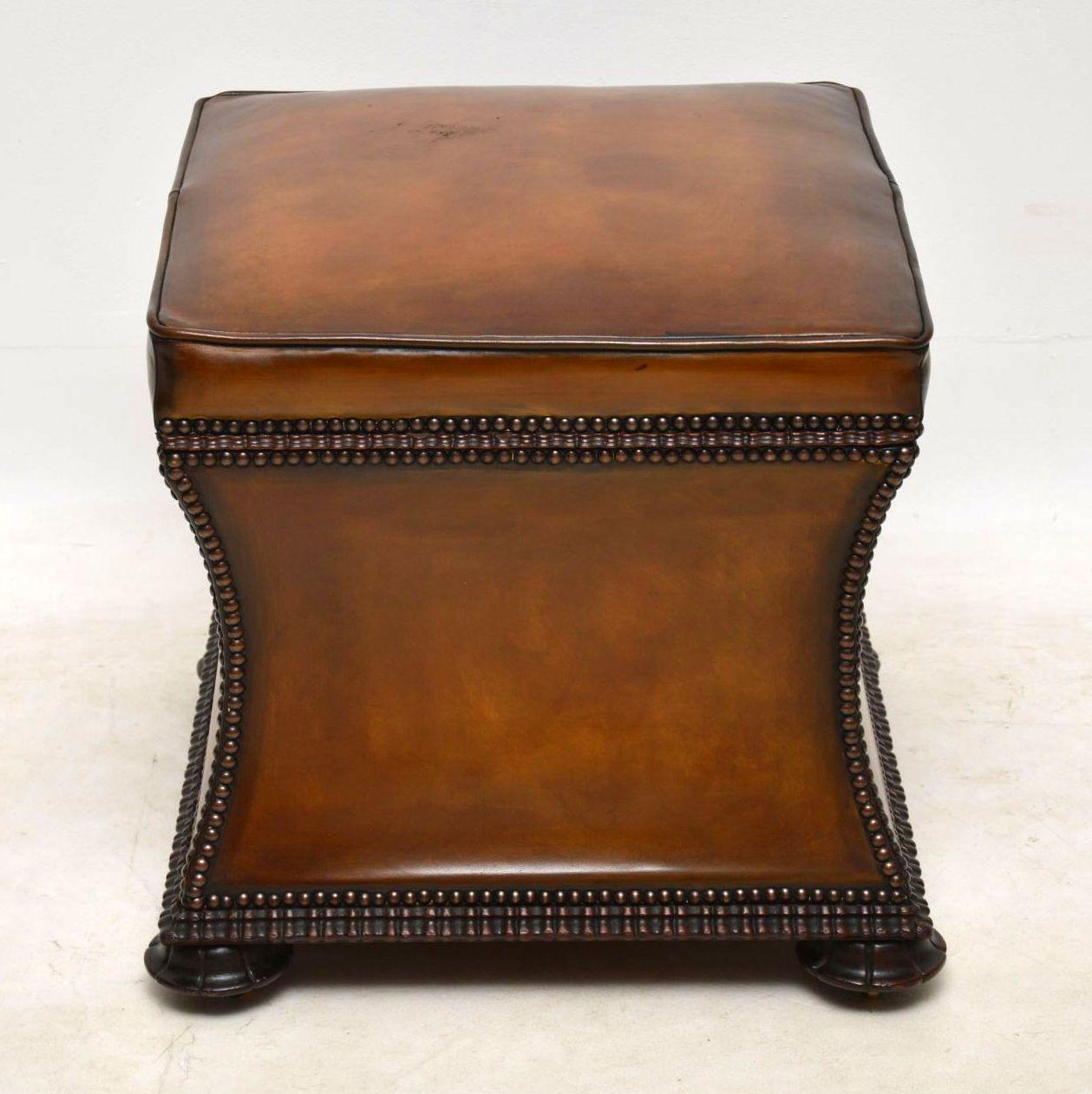 Antique William IV leather upholstered ottoman with useful storage inside. It has a padded seat, concave sides and a hinged seat that lifts up to reveal a newly upholstered interior. The leather is hand colored showing loads of character and it’s