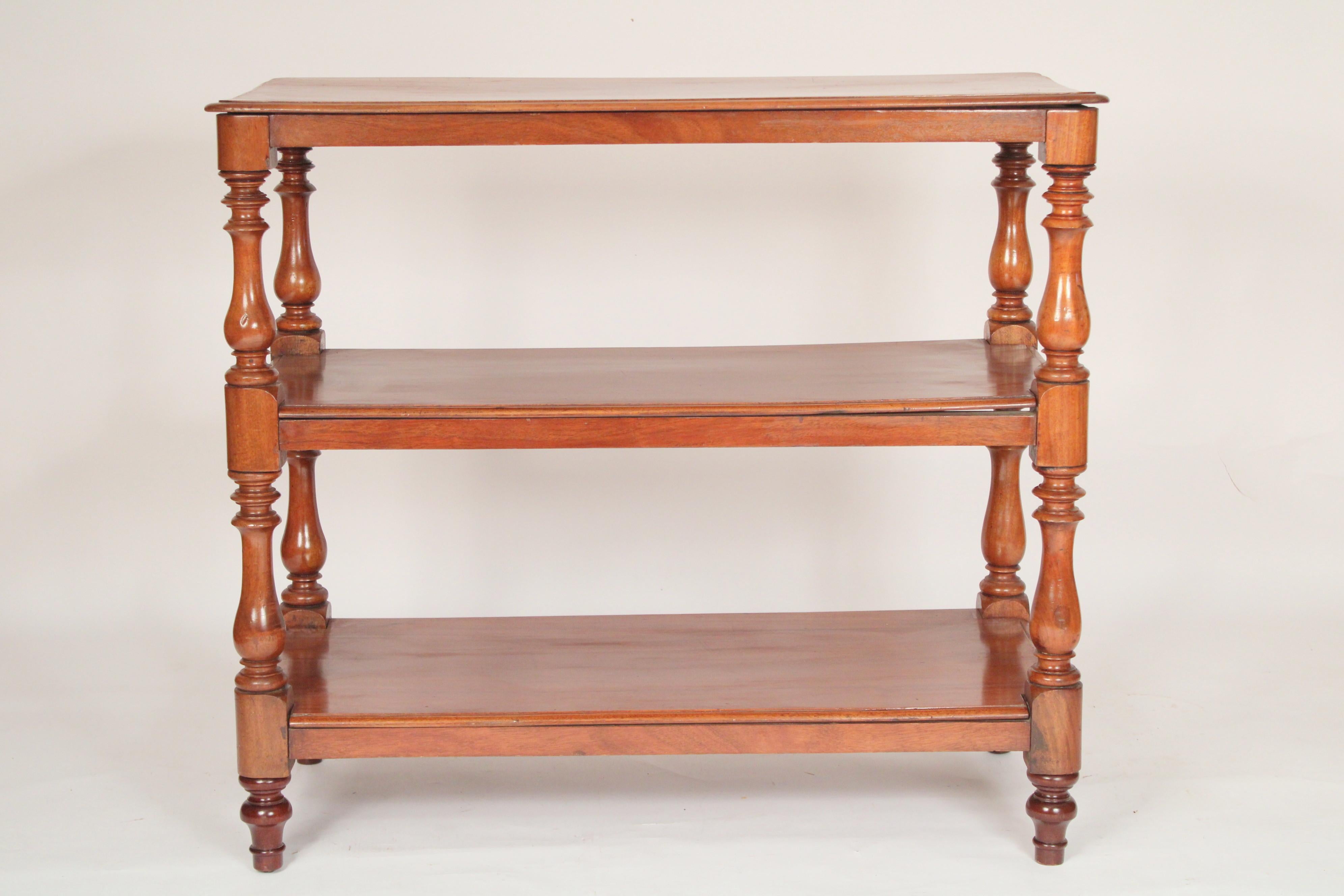 Antique William IV style mahogany 3 tier etagere, circa 1900. With a rectangular single board mahogany top with front, side and back molded edges, the two lower shelves with front and side molded edges, shelves supported by vase shaped supports.