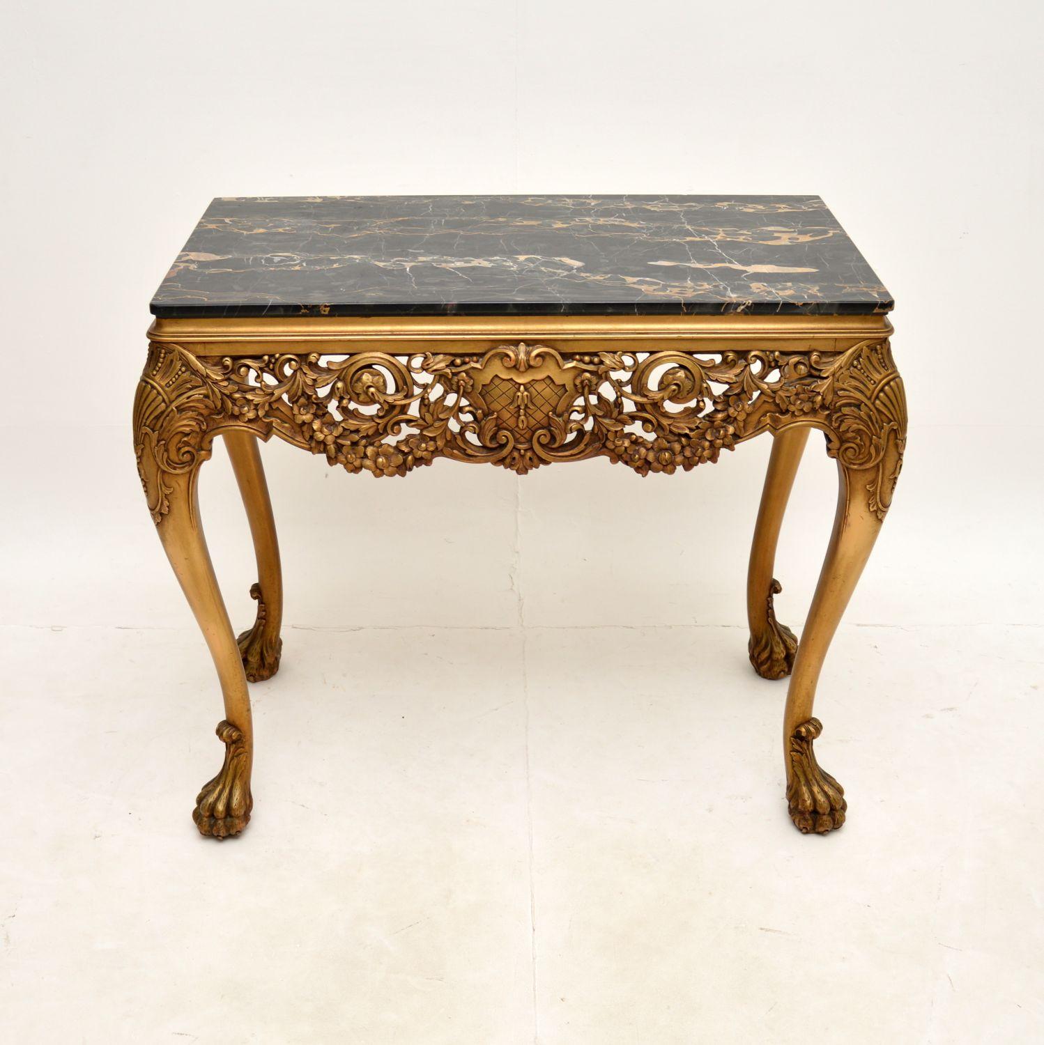A stunning antique William Kent style marble top gilt wood side table. This was made in England, it dates from around the 1930’s.

The quality is outstanding, this has fine and intricate carving throughout the gilt wood frame. The frame has a lovely