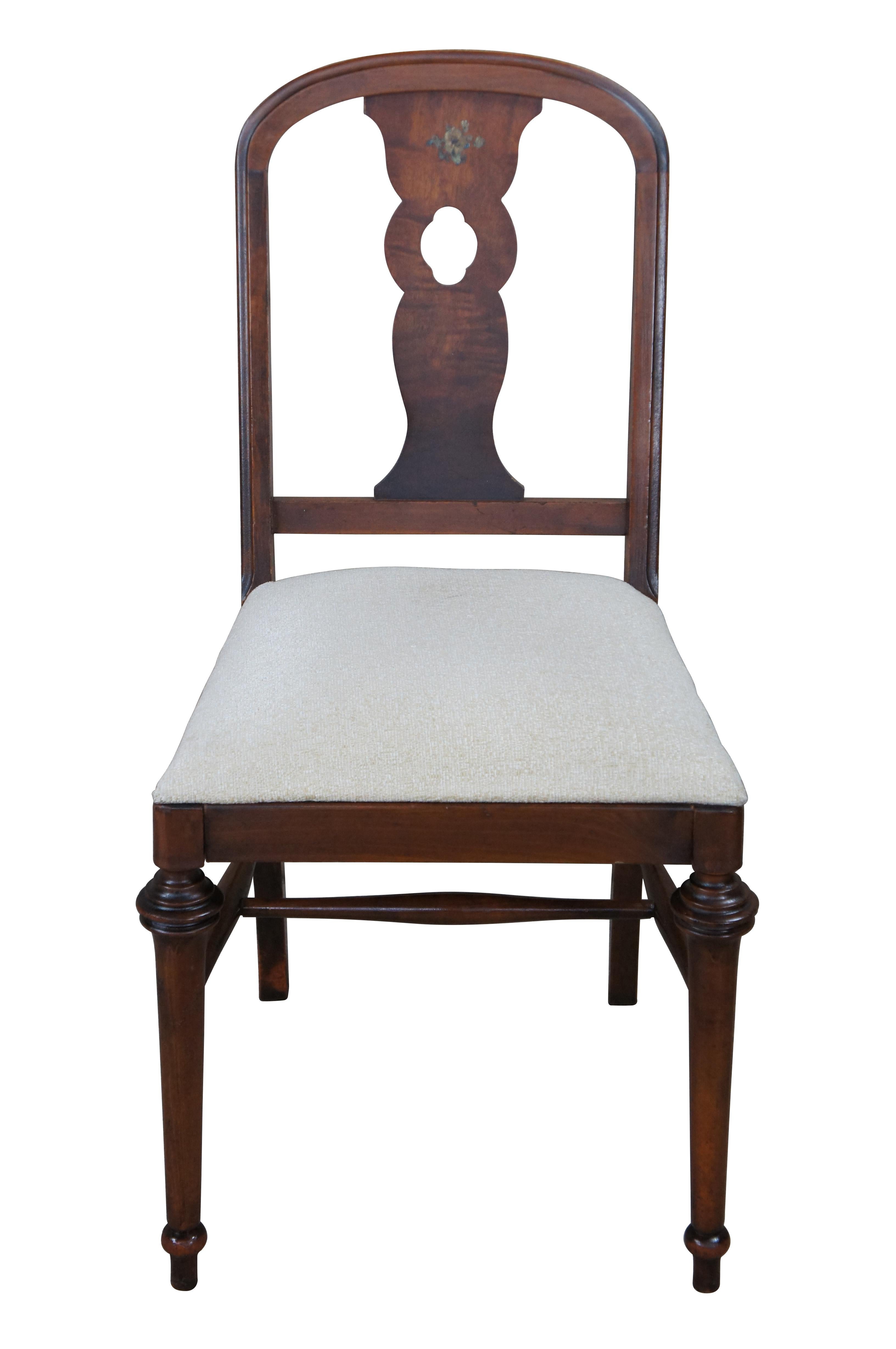 Antique William & Mary style dining, desk or library chair.  Made of walnut featuring pierced slat back with floral design and domed top, upholstered seat and turned legs.

Dimensions:
19