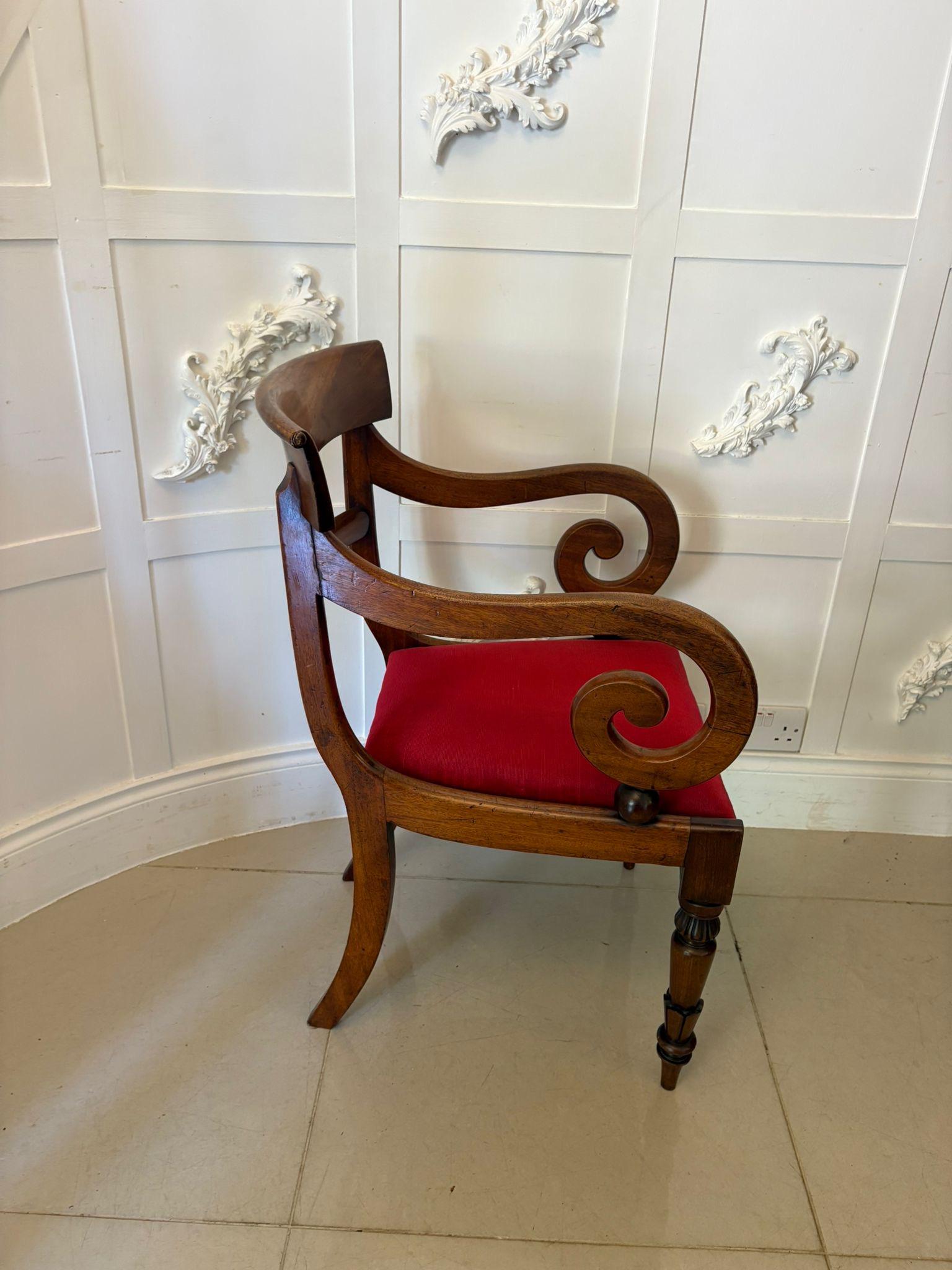Antique Willian IV quality mahogany desk chair having a quality mahogany shaped top and centre splat, shaped scroll open arm, newly reupholstered drop in seat in a quality fabric standing on carved turned tapering legs to the front and out swept