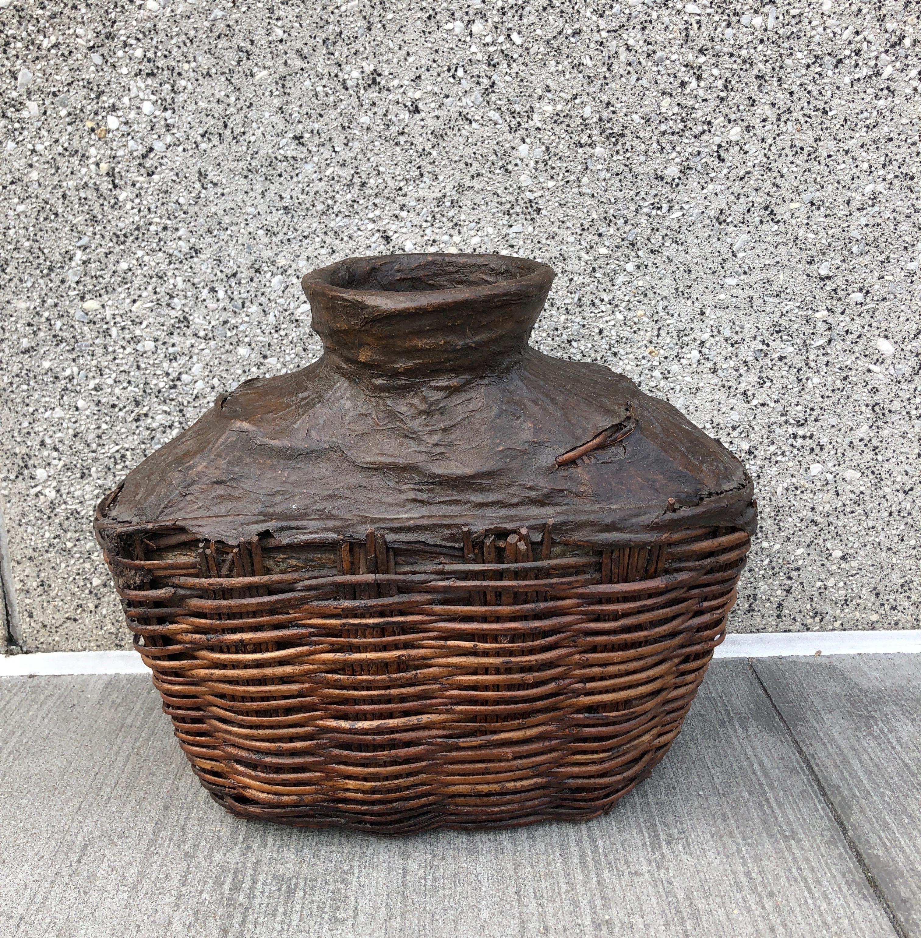 A classically shaped, hand woven antique willow food oil container from China, Shanxi Province, c. 1900.