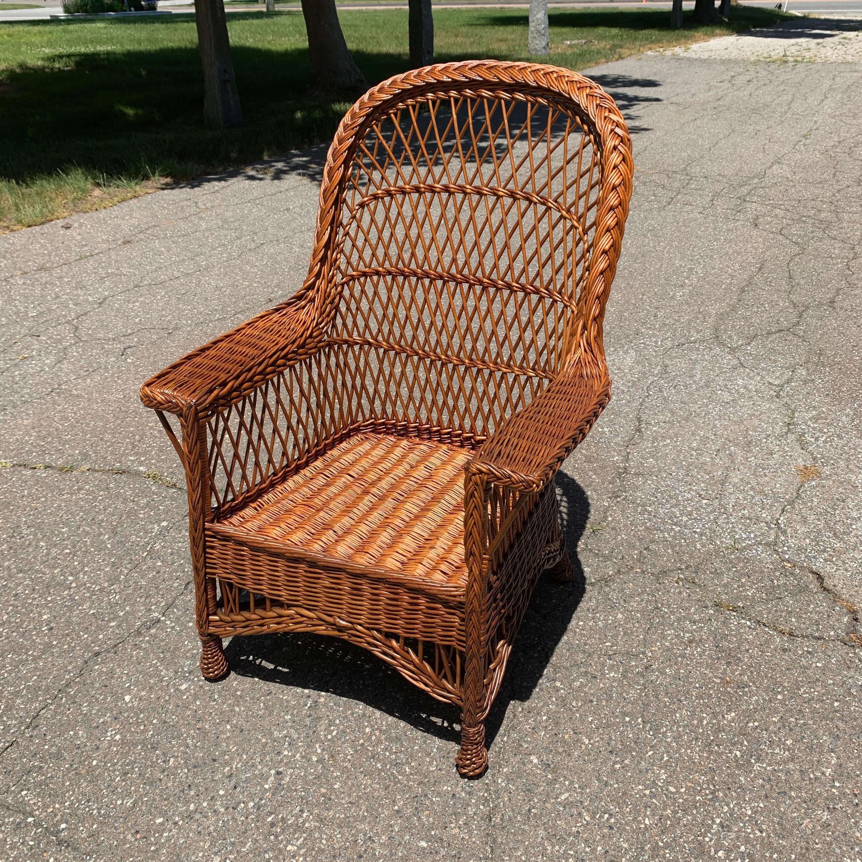 Antique Willow Wicker chair in a natural stain finish. Chair measures 43” tall, 32” wide, 29” deep and seat height is 15”.