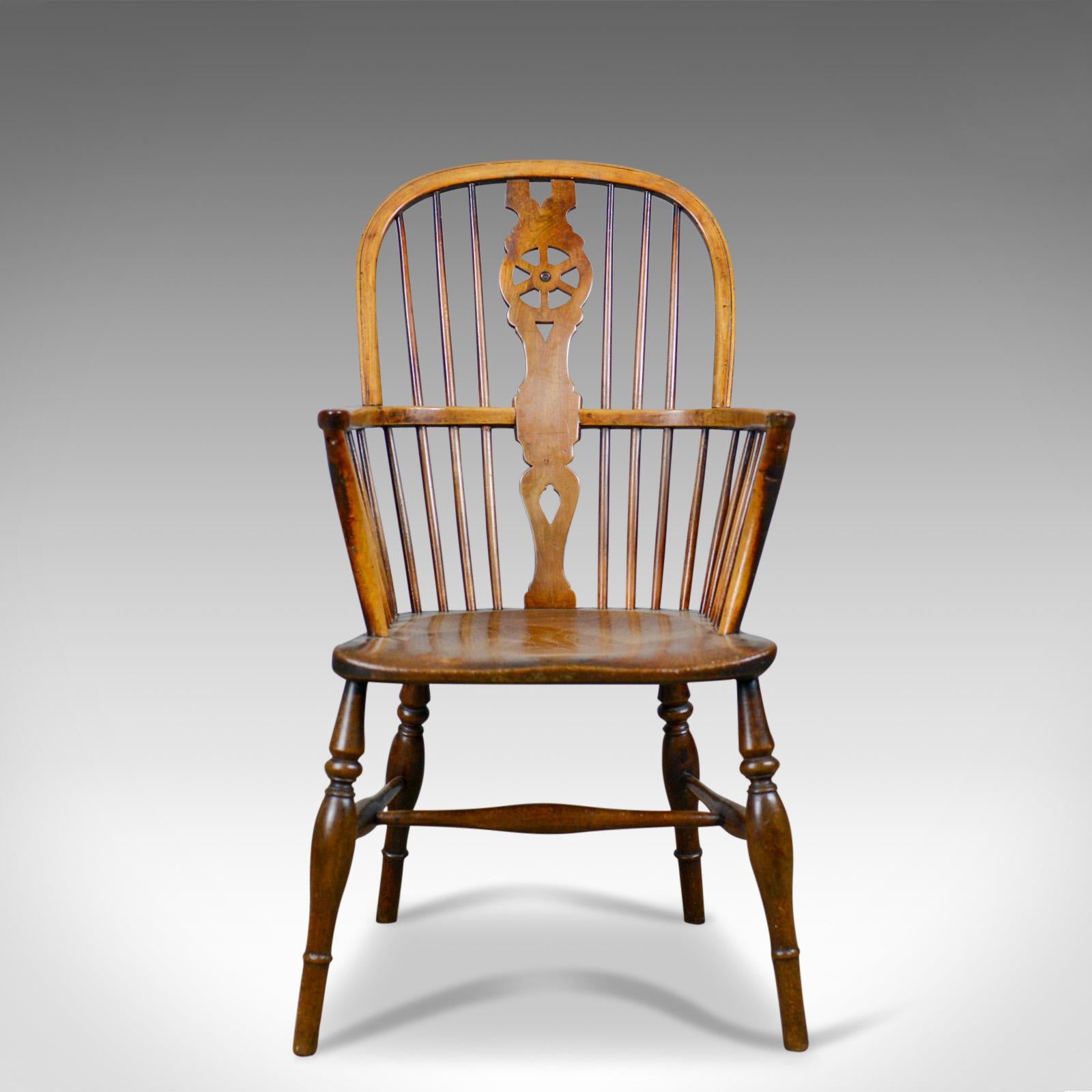 This is an antique Windsor armchair, an English Victorian, country kitchen, stick back elbow chair in elm, beech and ash dating to circa 1900.

Stunning chair in fine order throughout
Classic pierced back splat above and below the arm bow
Raked,