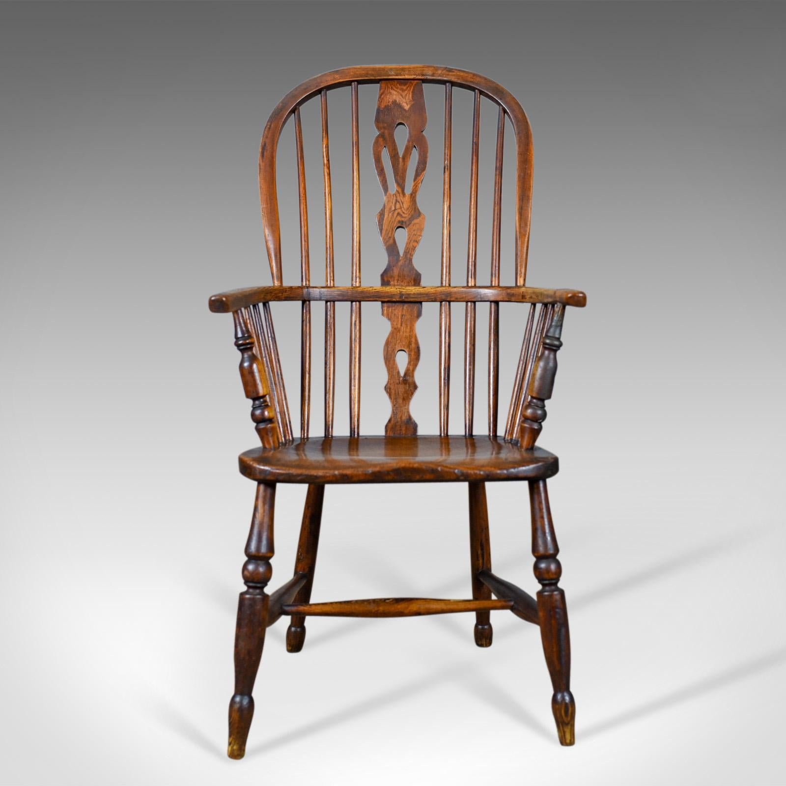 This is an antique Windsor armchair, an English Victorian, country kitchen, stick back elbow chair in elm and ash dating to circa 1860.

Stunning chair in fine order throughout
Classic pierced back splat above and below the arm bow
Raked,