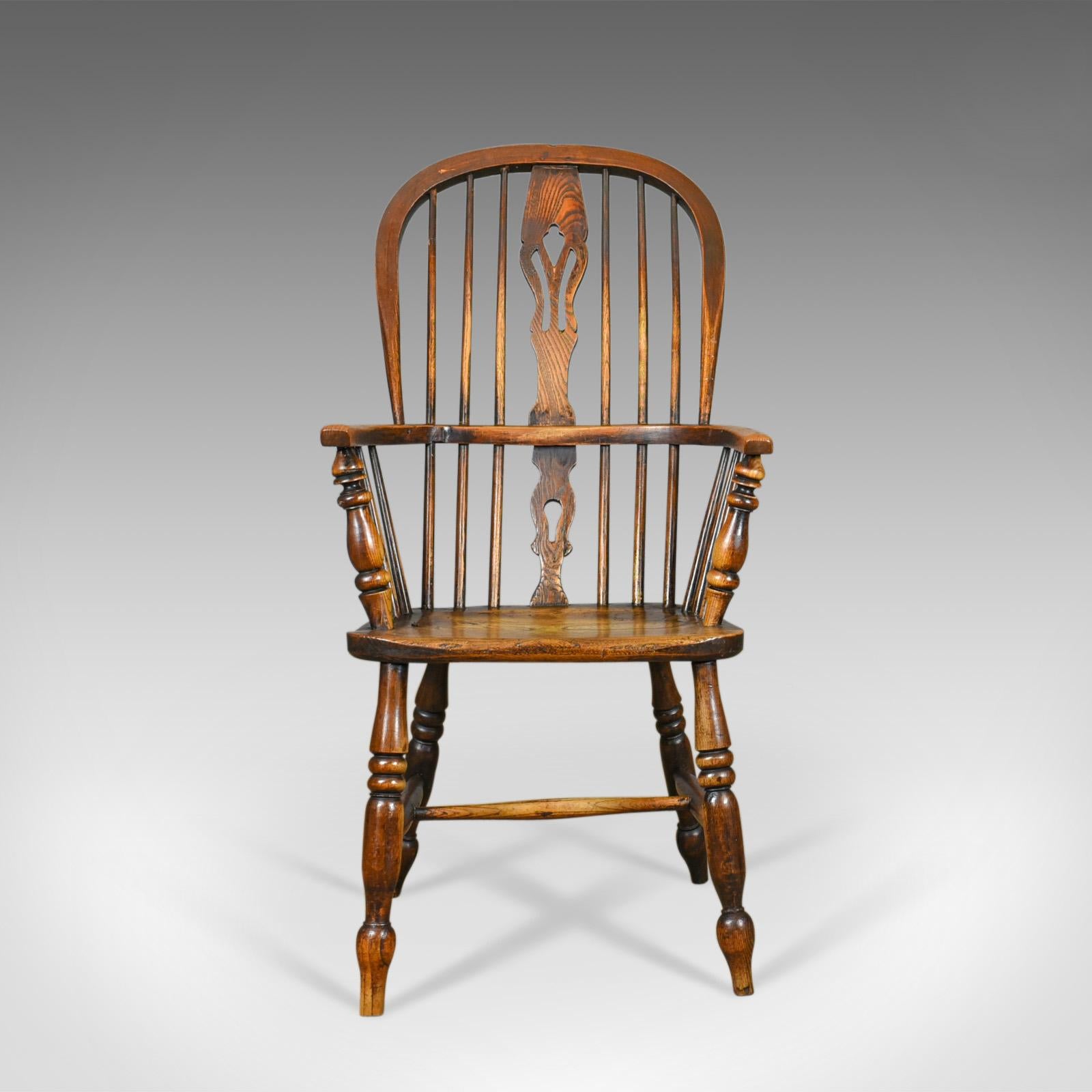 This is an antique Windsor armchair, a Victorian, country kitchen, stick back elbow chair in elm and ash dating to circa 1850.

Stunning chair in fine order throughout
Classic pierced back splat above and below the arm bow
Raked, bentwood back