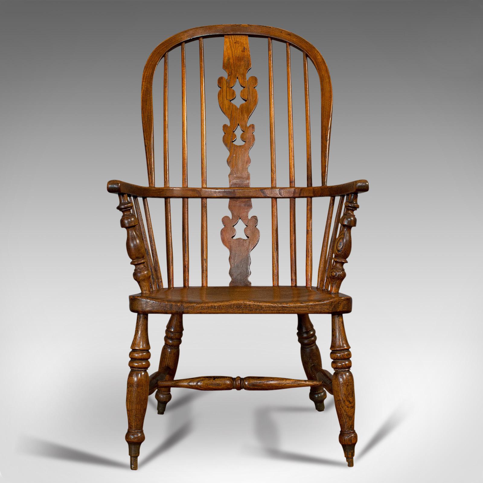 This is an antique Windsor chair. A British, elm and ash elbow or armchair, dating to the mid-Victorian period, circa 1860.

Country house appeal
Displays a desirable aged patina
Elm and ash show fine grain interest
Appealing in color with rich