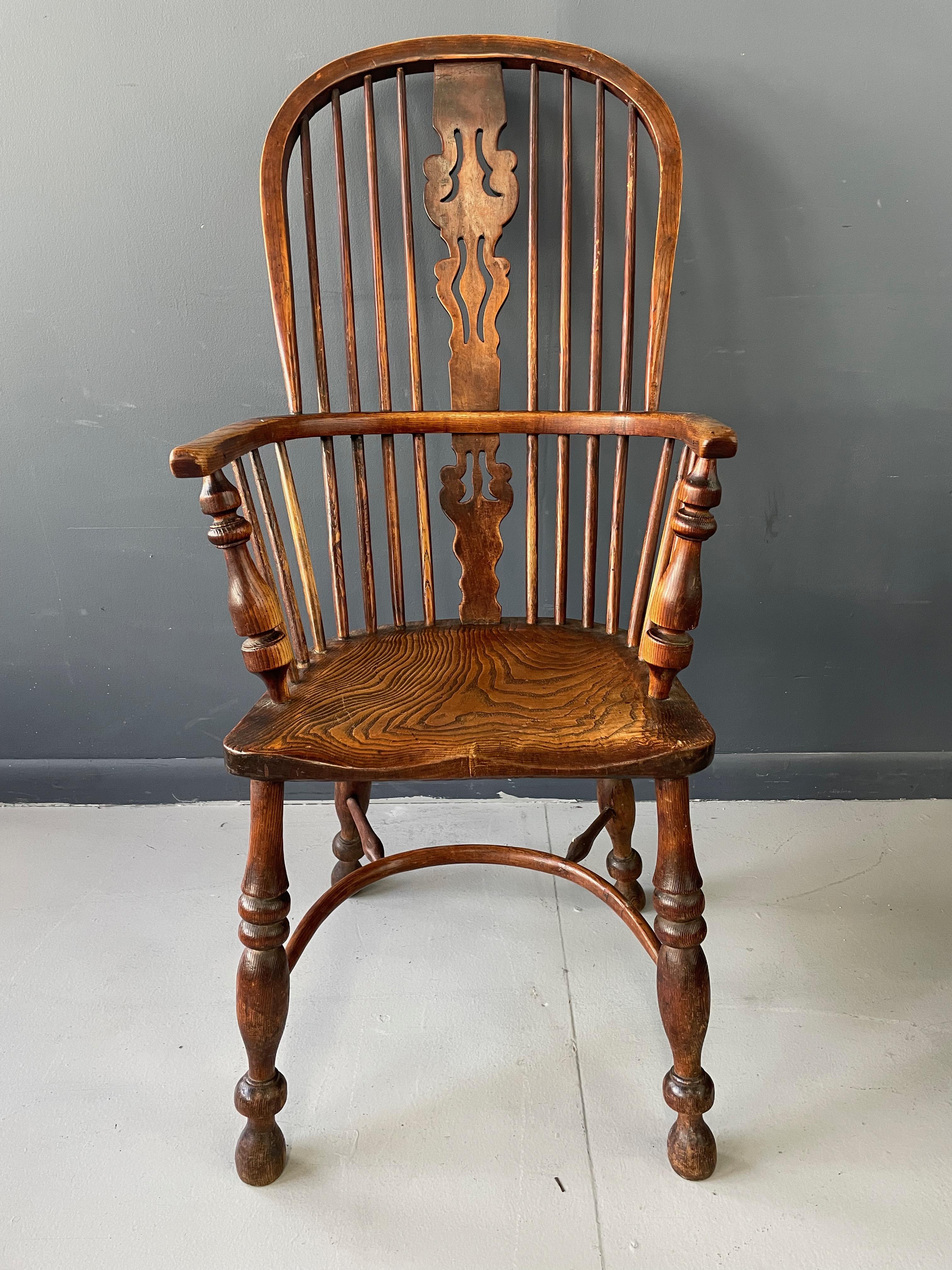 This is an antique Windsor elbow chair, a Victorian, double hoop armchair in elm and ash and dating to circa the mid-19th century, circa 1850. Classic English, country, elbow chair Triple fret-cut back splat over key hole lower Raked, bentwood back