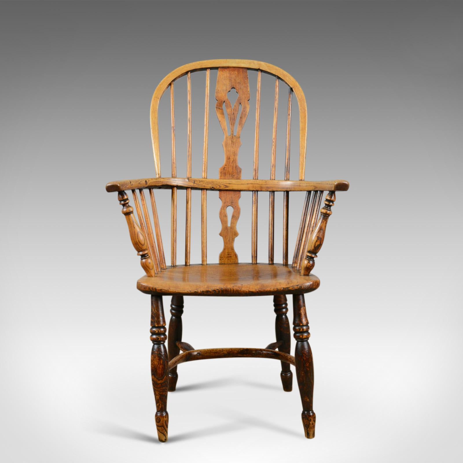 This is an antique Windsor elbow chair, a Victorian, double hoop armchair in elm and ash and dating to circa the mid-19th century, circa 1850.

Classic English, country, elbow chair
Triple fret-cut back splat over key hole lower
Raked, bentwood